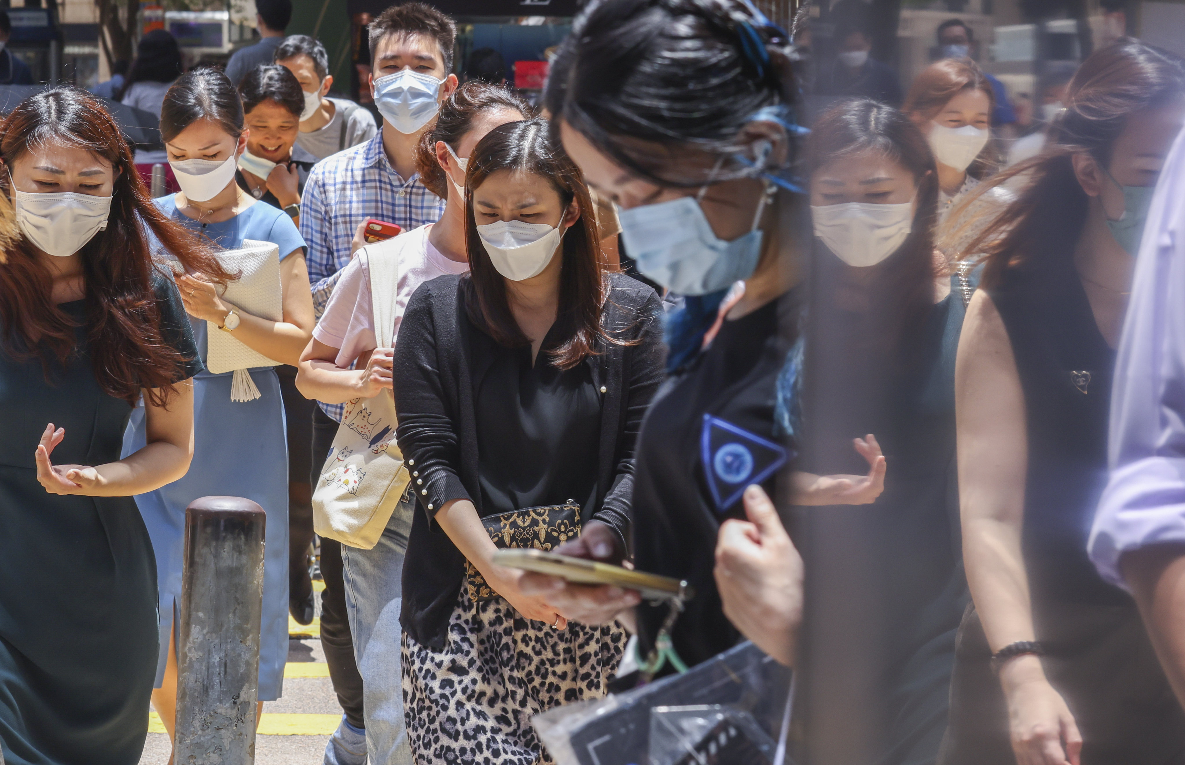 People wearing face masks in Central on August 15. Our Covid-19 regime is a deterrent to visiting Hong Kong, whether for business or pleasure. Photo: Nora Tam