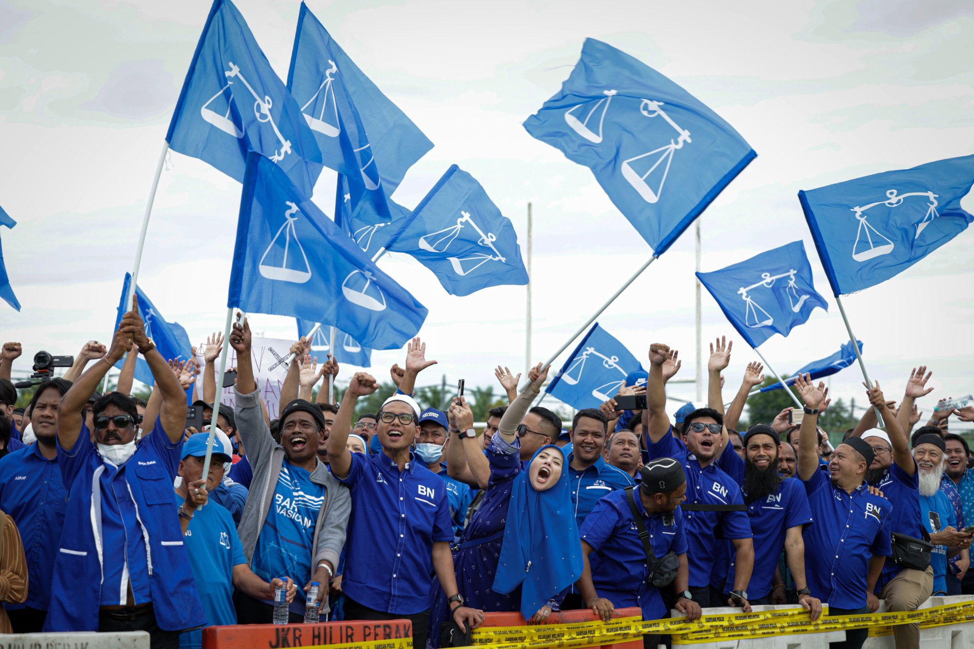 Supporters of the Barisan Nasional party in Malaysia support candidates as they arrive to submit nomination documents for the coming general election. Photo: dpa