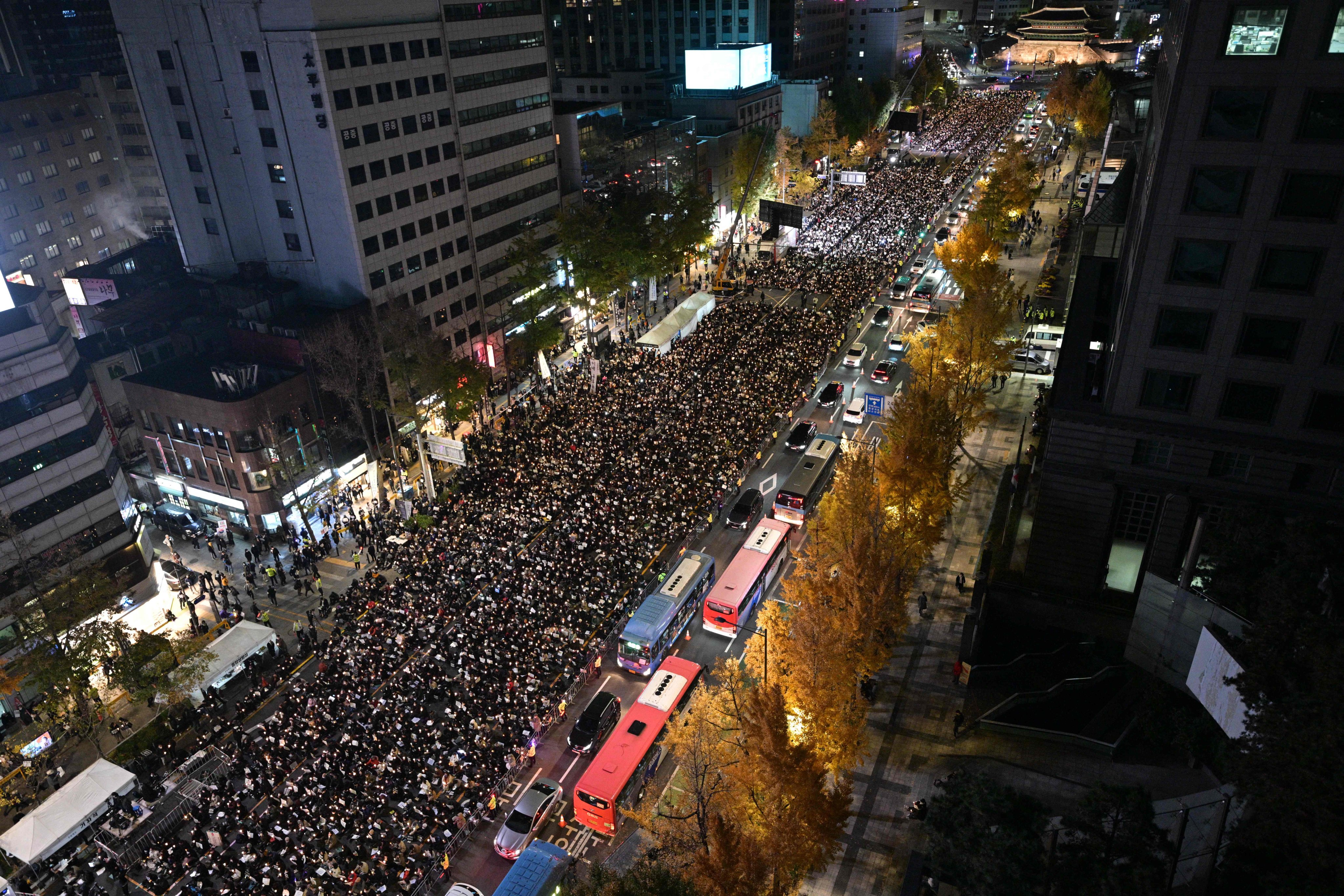 Mourners take part in a candlelight vigil in Seoul on Saturday to commemorate the 156 people killed in the October 29 Halloween crowd crush. Photo: AFP