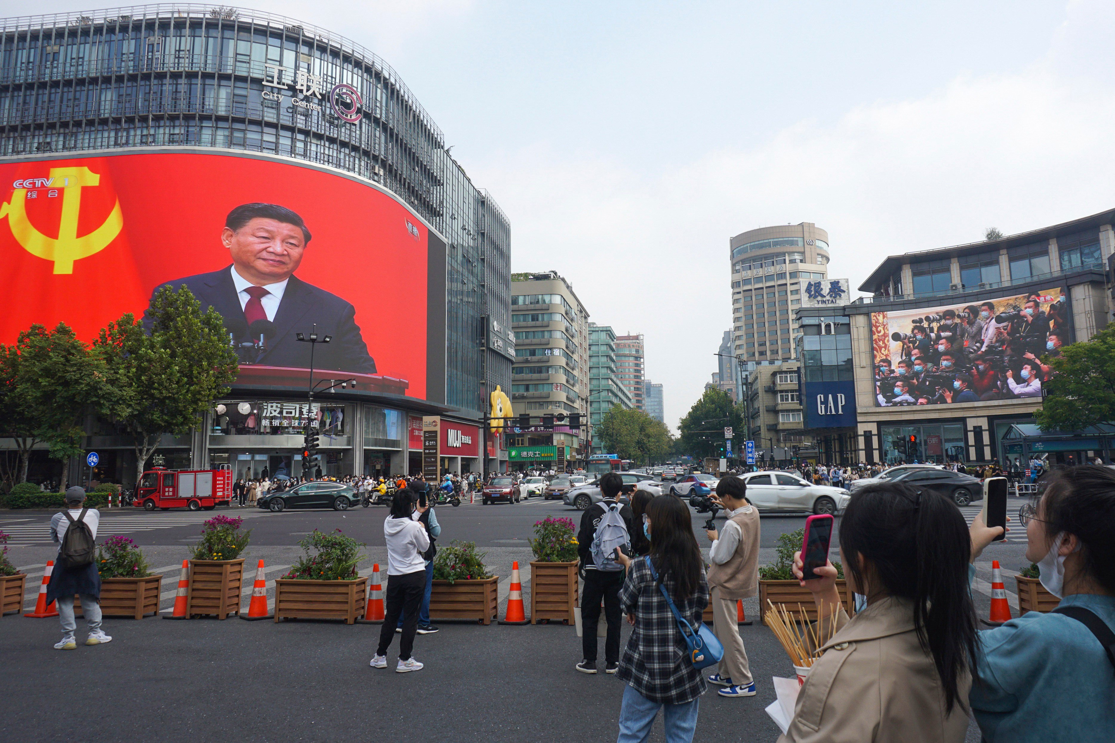 Chinese President Xi Jinping is seen at the end of the 20th party congress on a giant screen in a Hangzhou commercial district in Zhejiang province on October 23. Photo: AP