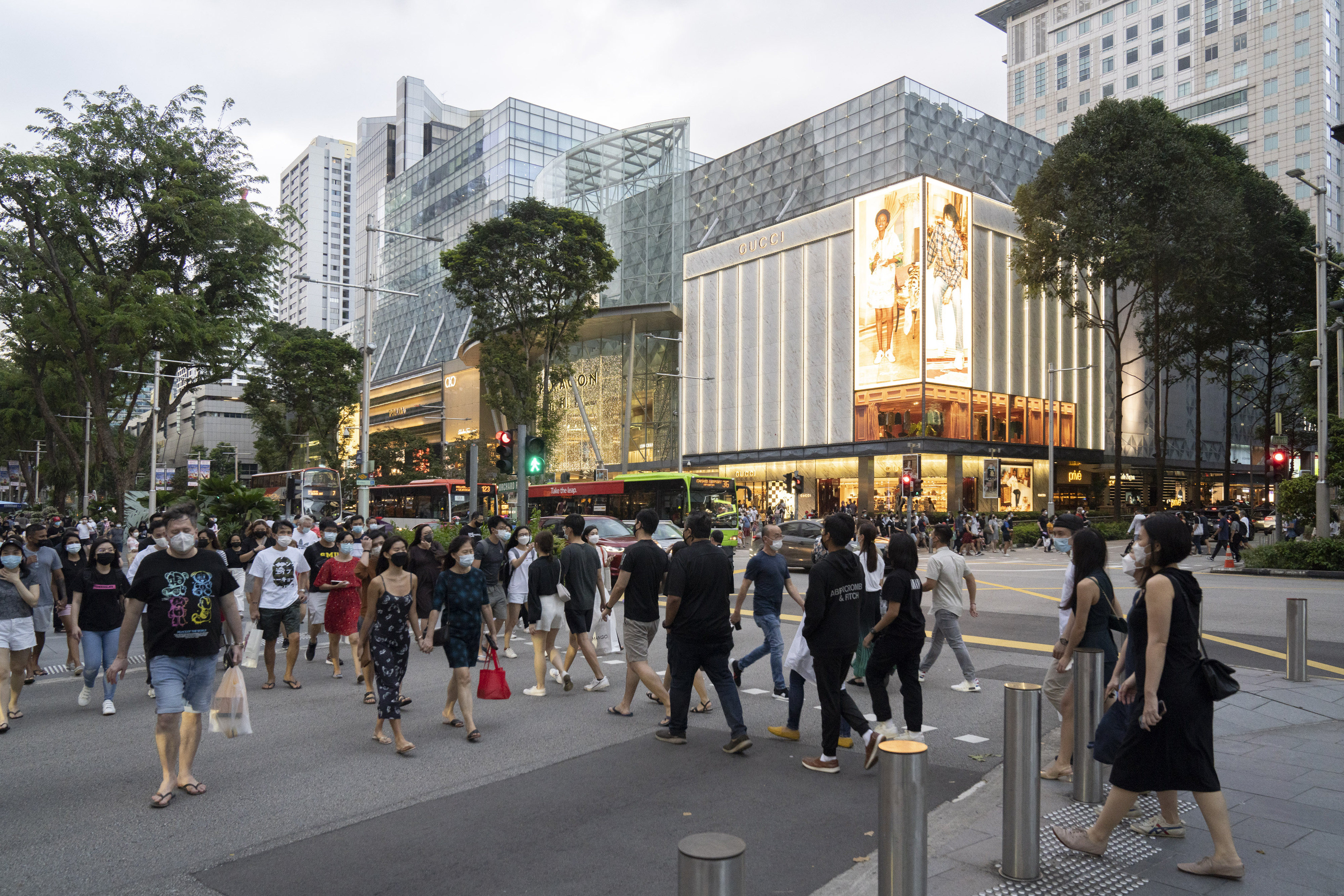 Shoppers on Orchard Road in Singapore. The government will also increase an existing aid package to offset the impact of the GST hike to S$8 billion, from S$6.6 billion previously. Photo: Bloomberg