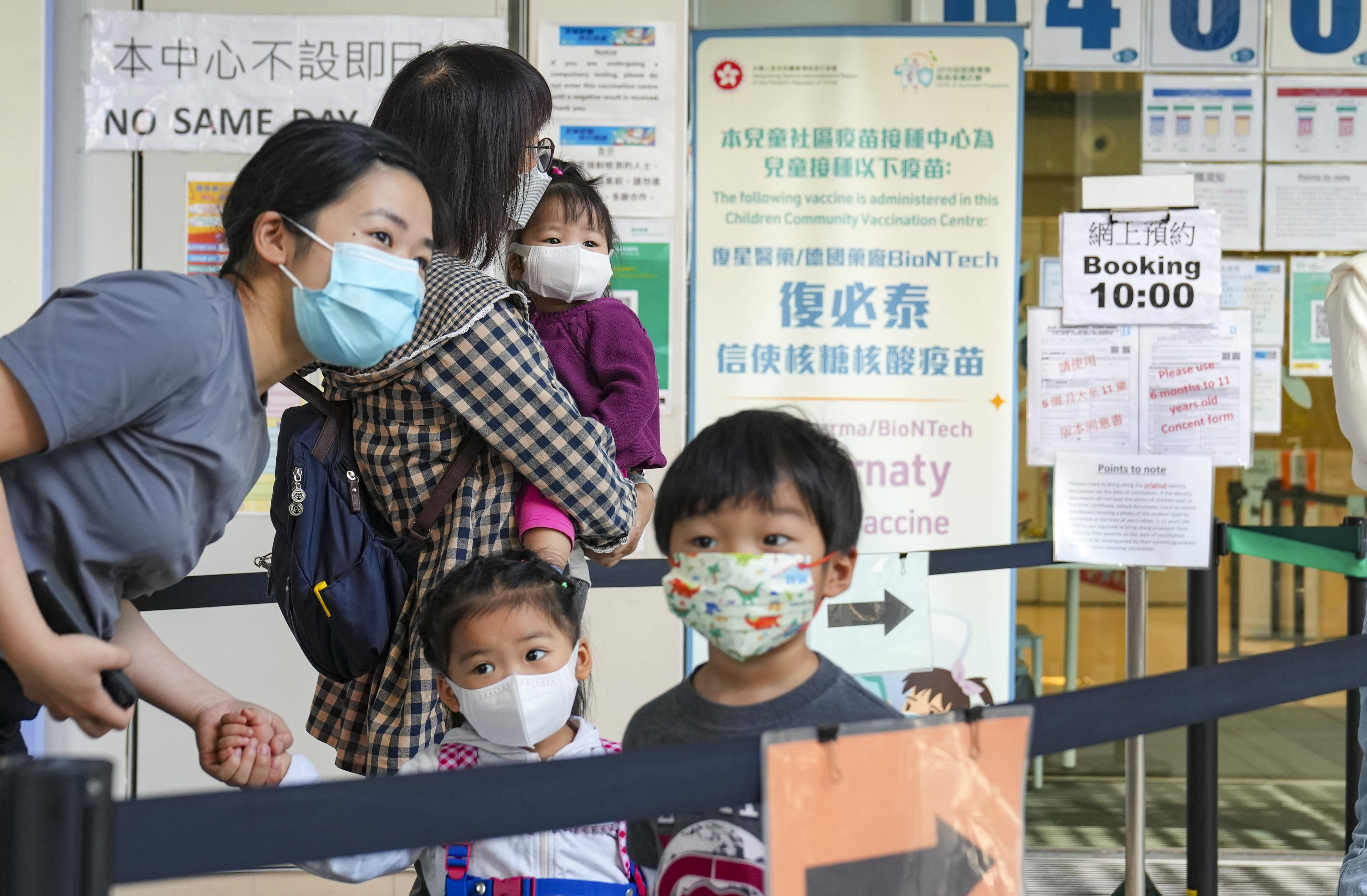 Parents bring their young ones to Hong Kong Children’s Hospital in Kai Tak on the first day of the BioNTech toddlers’ jab roll-out. Photo: Sam Tsang