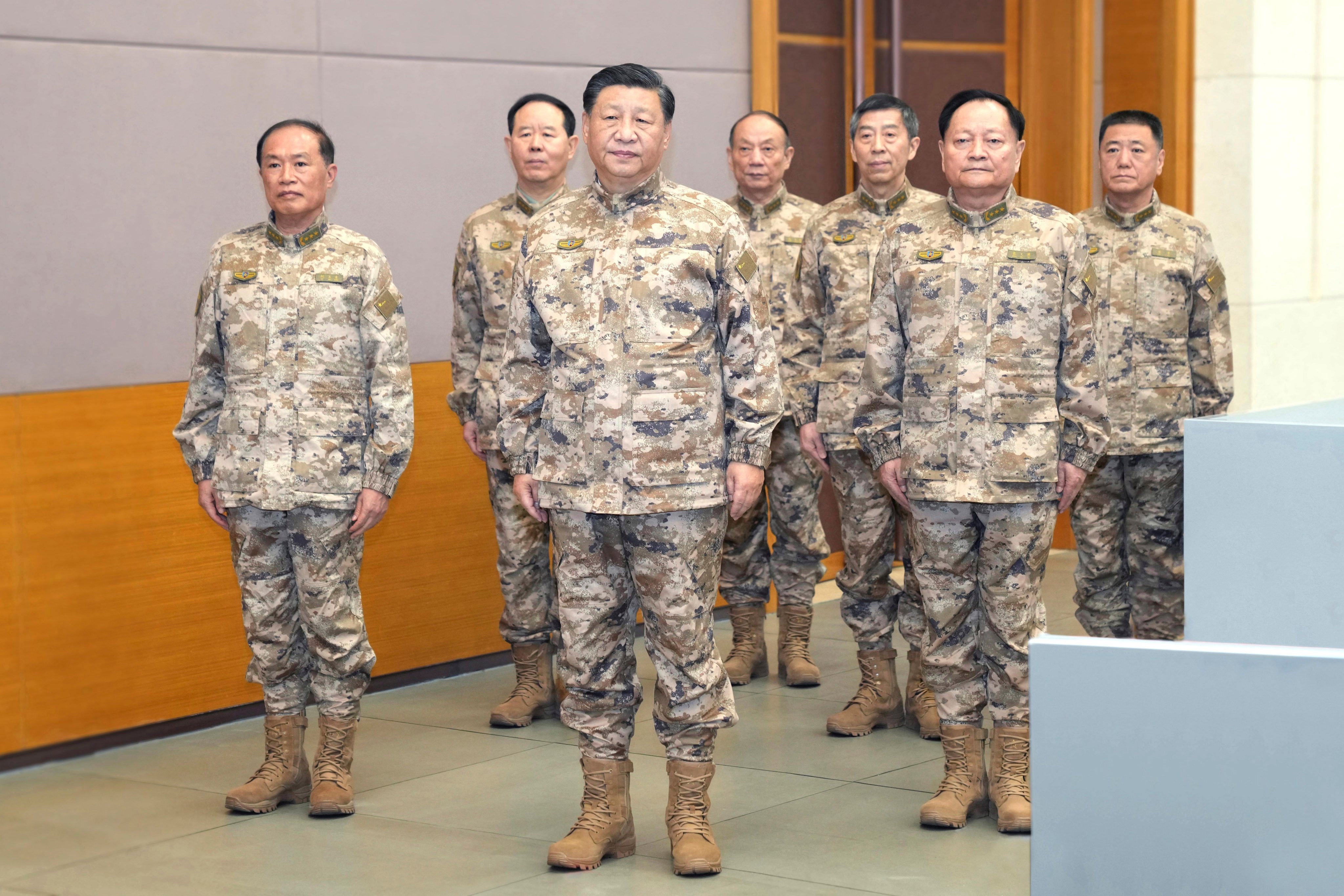 President Xi Jinping (front centre) stands with the members of the Central Military Commission, including vice-chairmen Zhang Youxia (front right) and He Weidong (front left), at the CMC joint operations command centre on November 8. Photo: Xinhua via AP