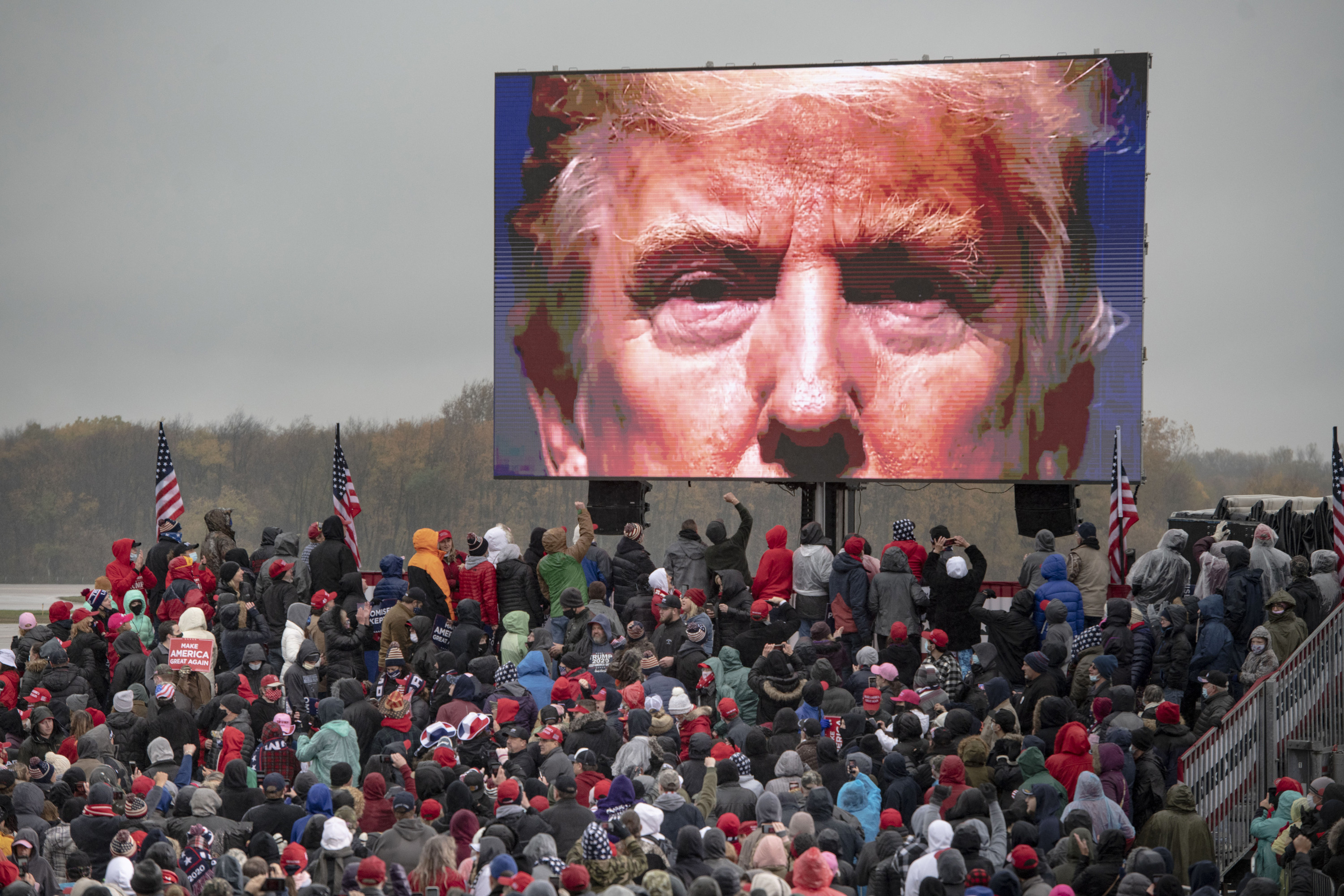 Trump supporters watch a video during a campaign event in Lansing, Michigan, in October 2020. Photo: Ann Arbor News via AP