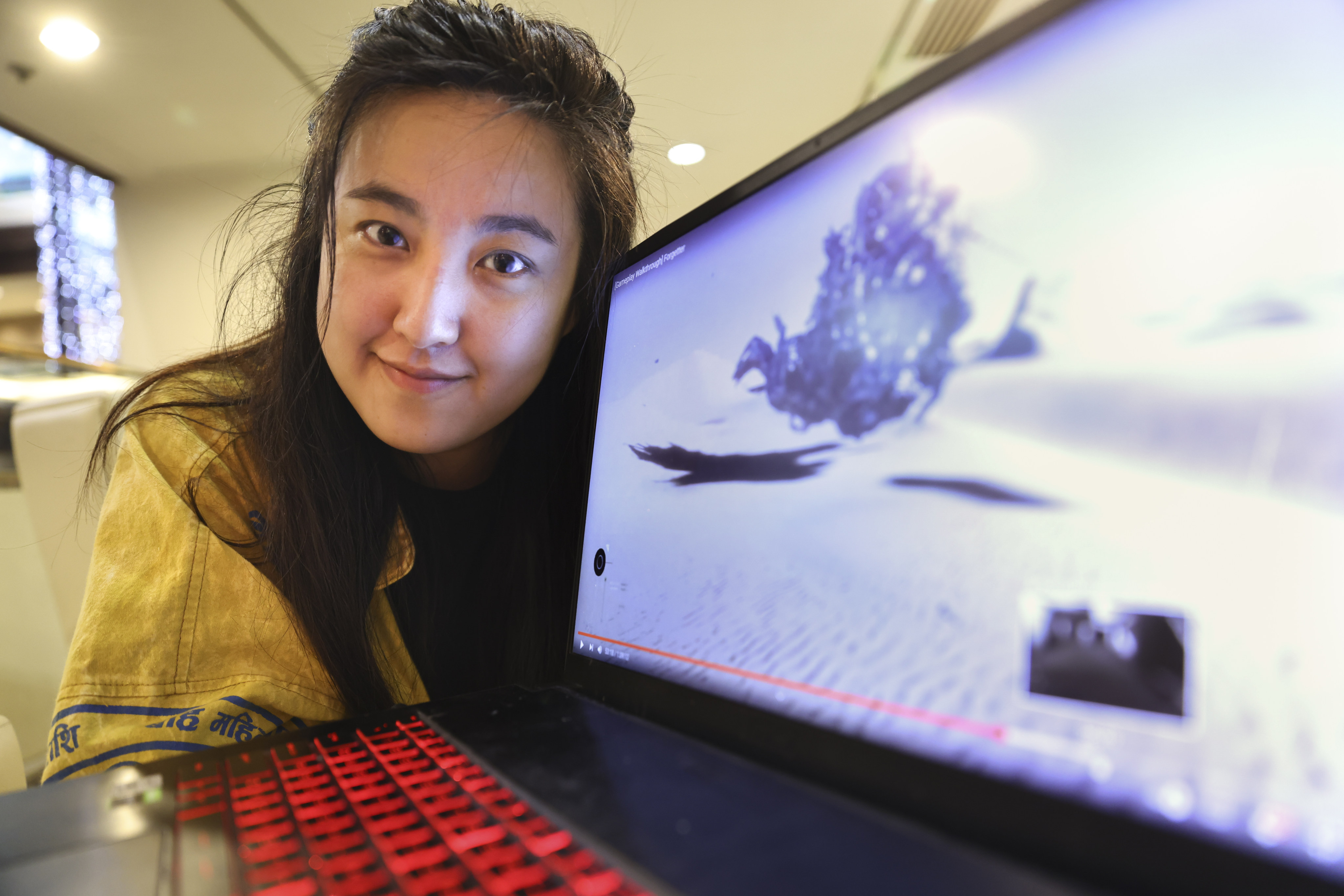 Game developer, producer and curator Allison Yang with a video of Forgetter, a game she is working on that has already won several awards. Photo: K.Y. Cheng