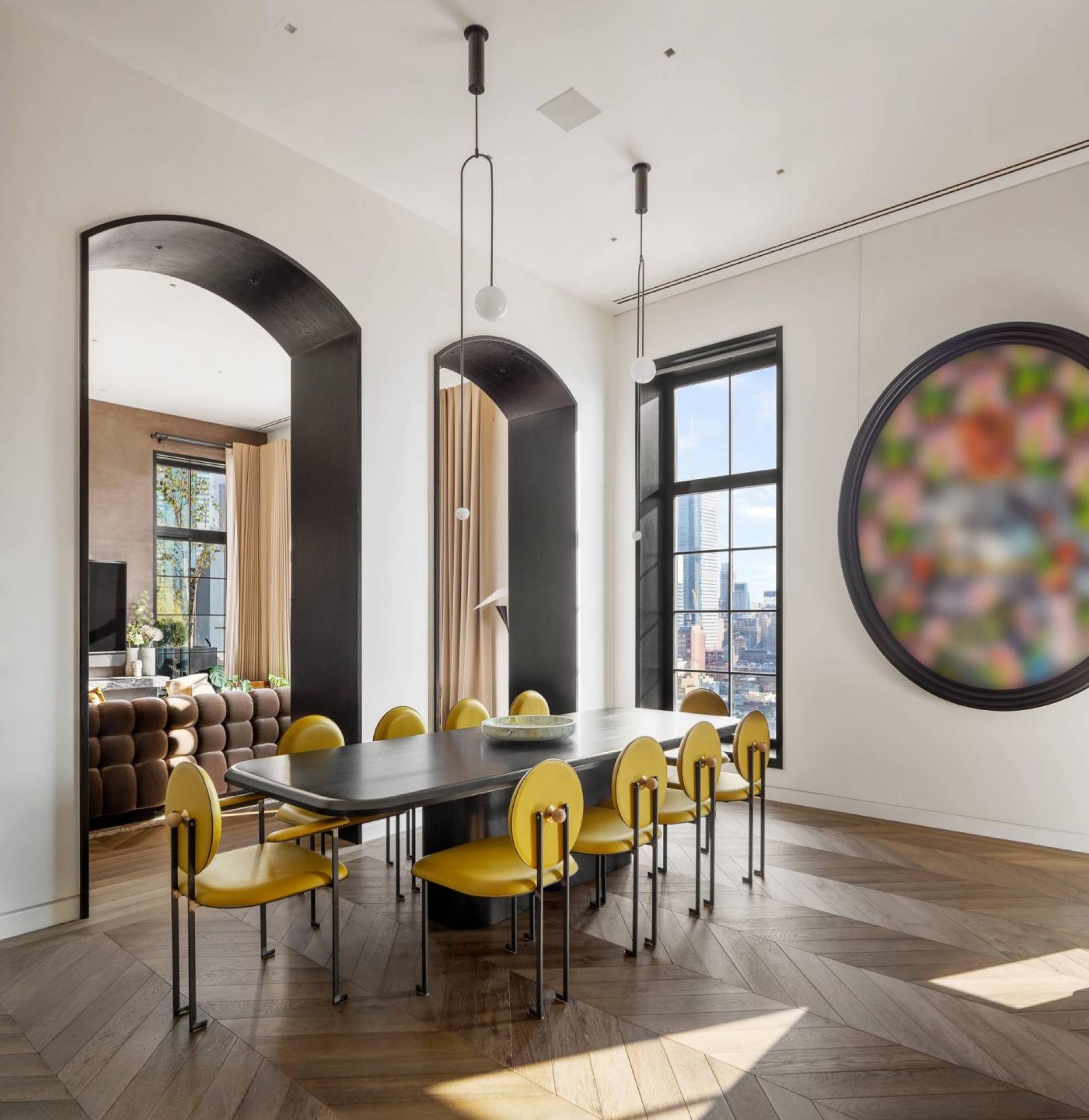 Trevor Noah’s dining room features artworks and bright yellow chairs for pops of colour.