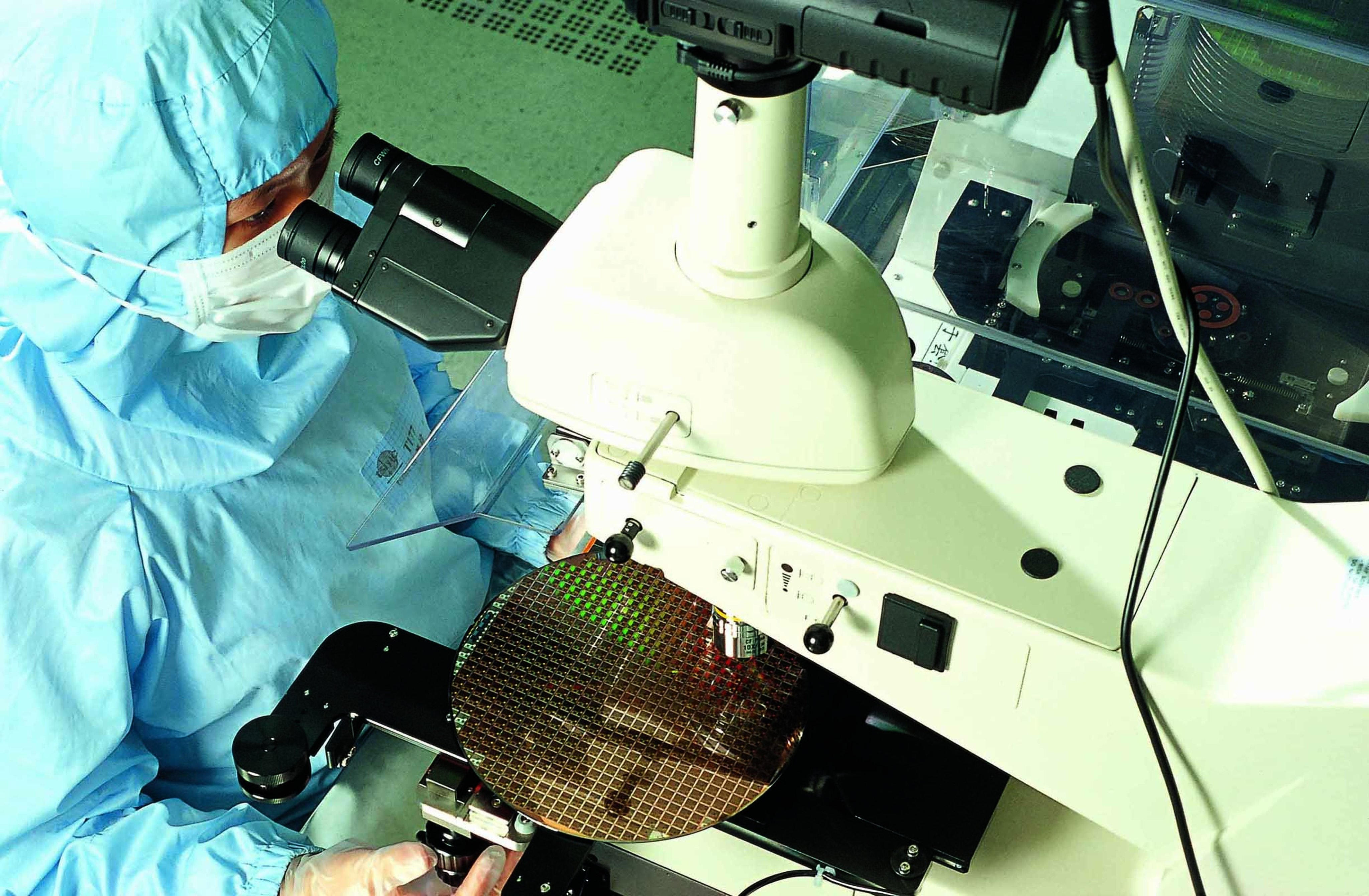 A worker inspects a semiconductor wafer at chip manufacturing giant Taiwan Semiconductor Manufacturing Company Ltd. Photo: TSMC Handout