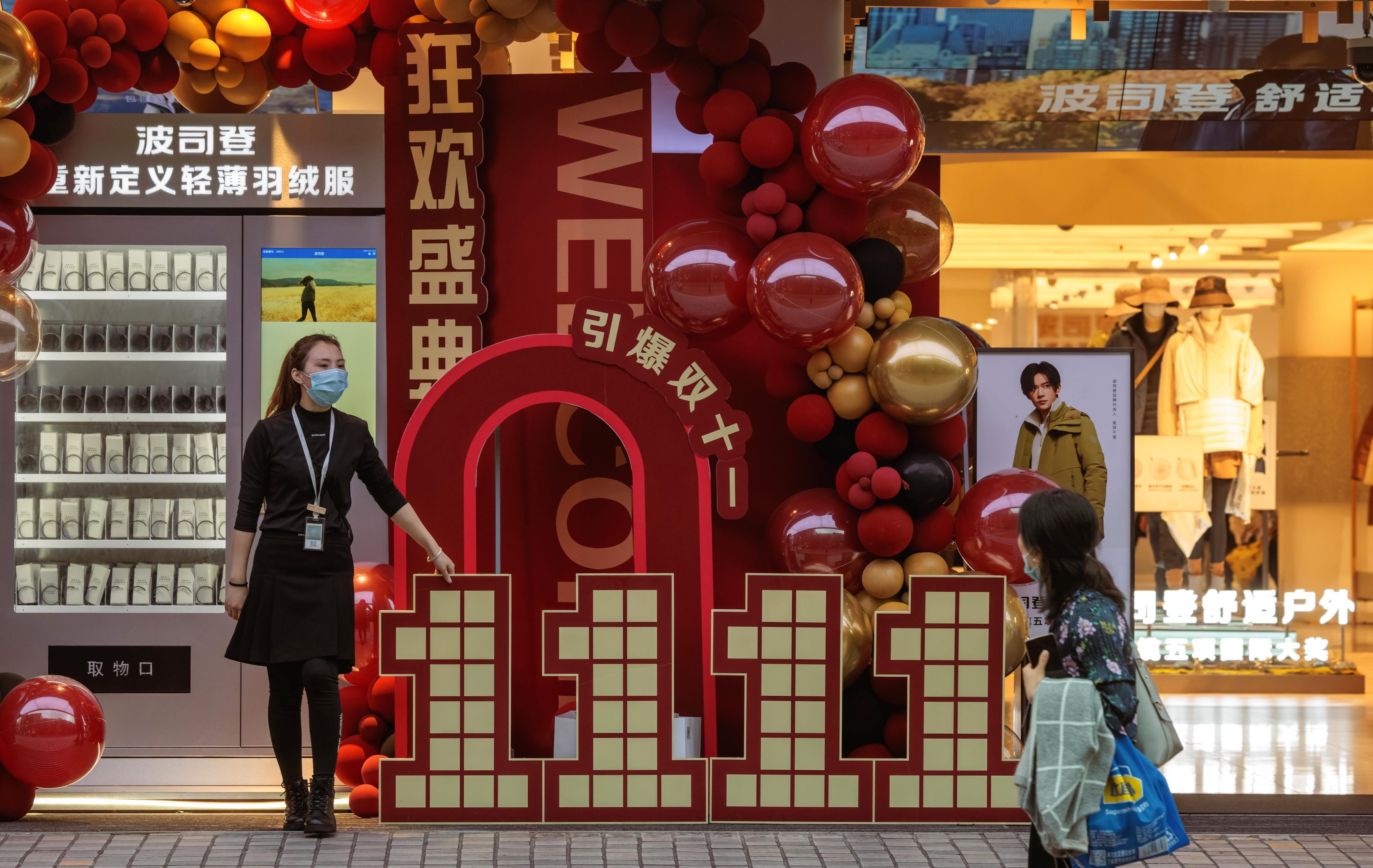 A shop employee promotes Singles’ Day discounts in Shanghai on November 11, 2022. Photo: EPA-EFE