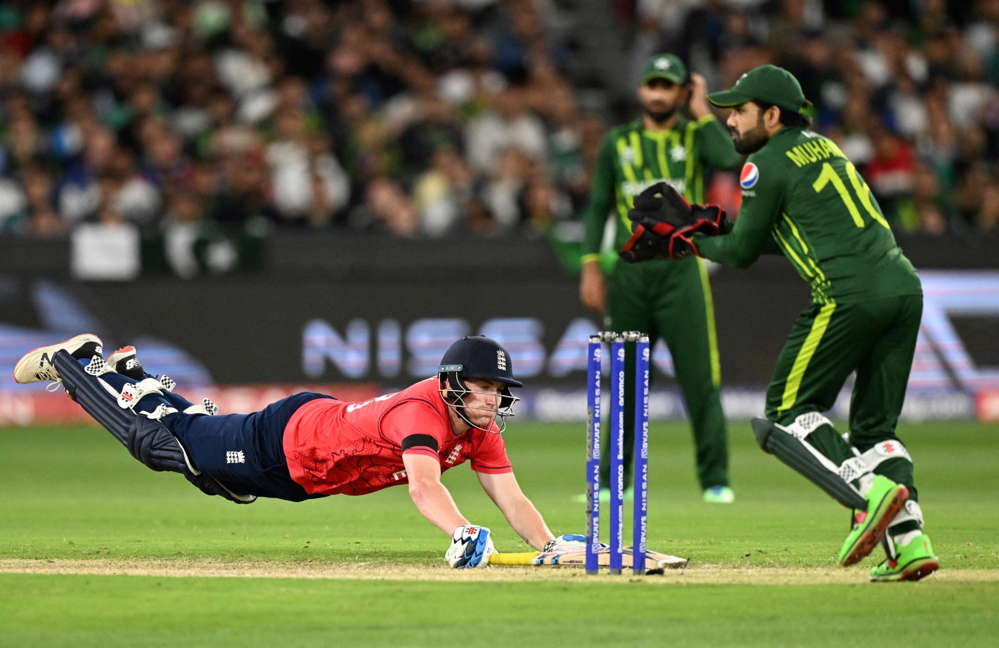 England’s Harry Brook dives to make his ground as Pakistan’s Muhammad Rizwan fields the ball. Photo: AFP
