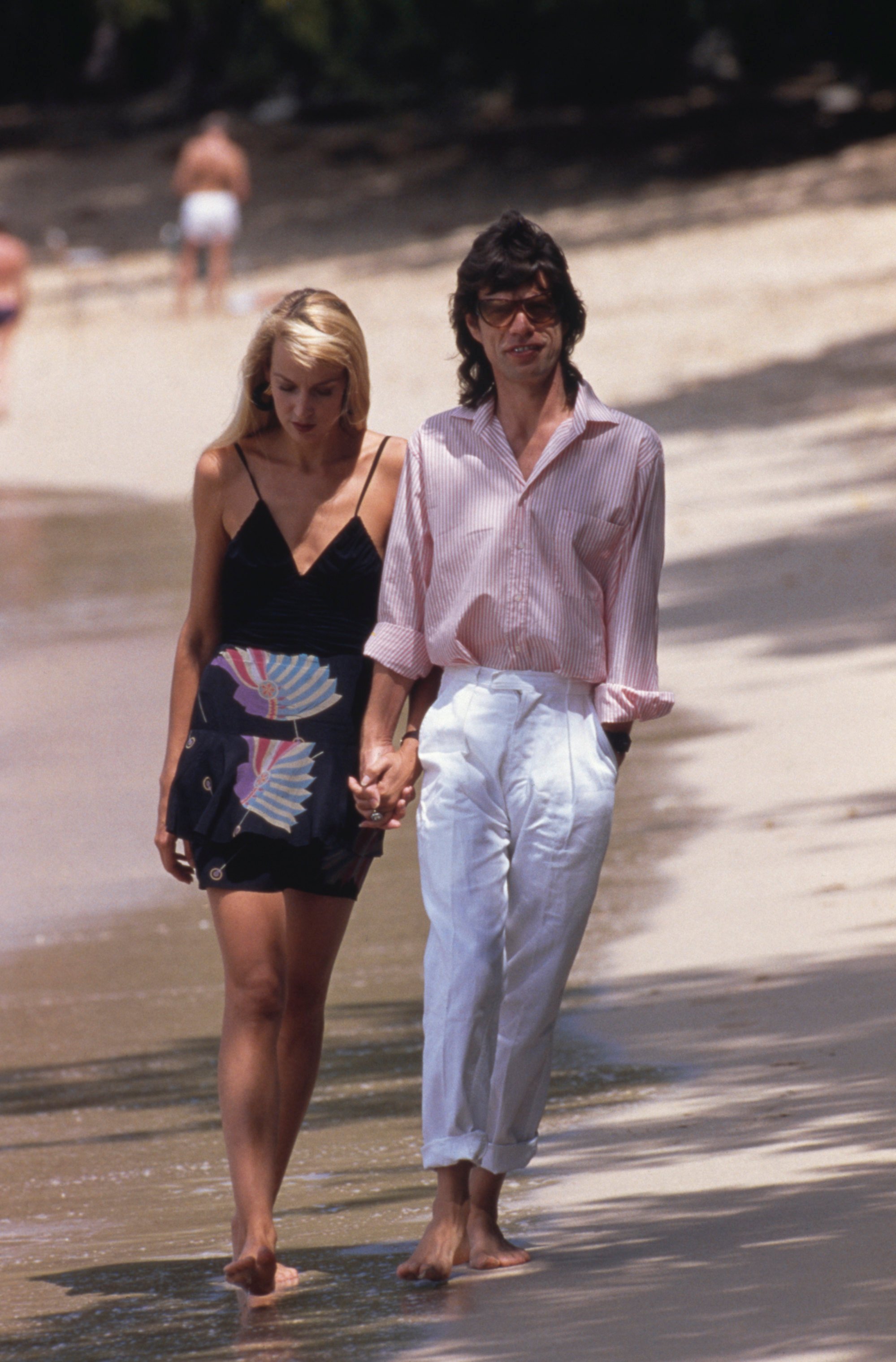 Mick Jagger and Jerry Hall on a beach in Mustique, in 1987. Photo: Getty Images