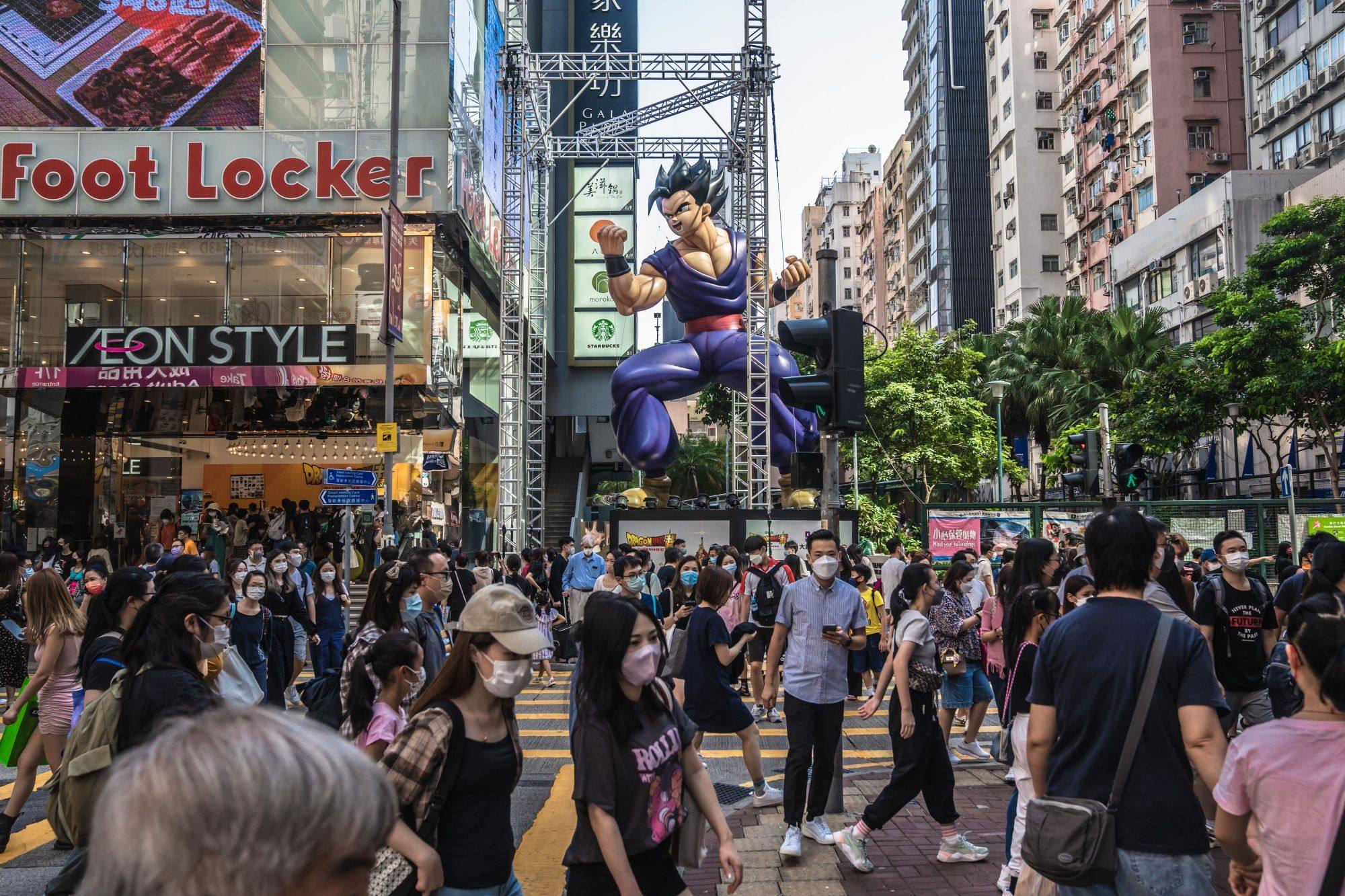 Pedestrians cross a road in Hong Kong on October 15. Hong Kong wants to bolster its status as a global financial hub following the disruptions caused by the pandemic. Photo: Bloomberg