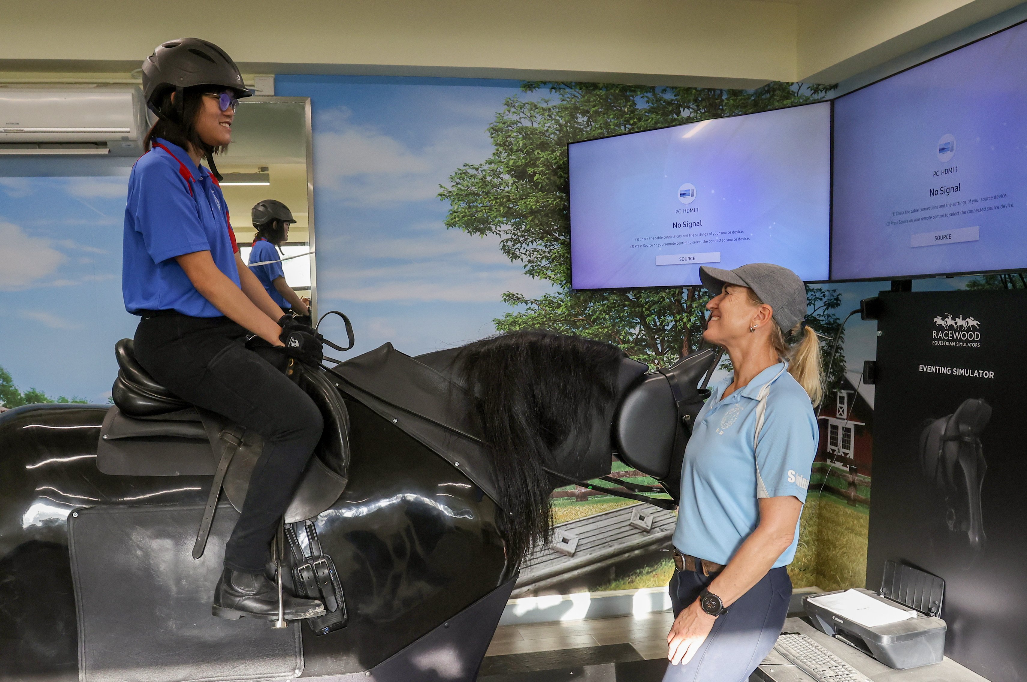 RDA supervising instructor Sabine Behrendt (right) and rider Leong Pui-yee demonstrate the simulator programme. Photo: Jonathan Wong