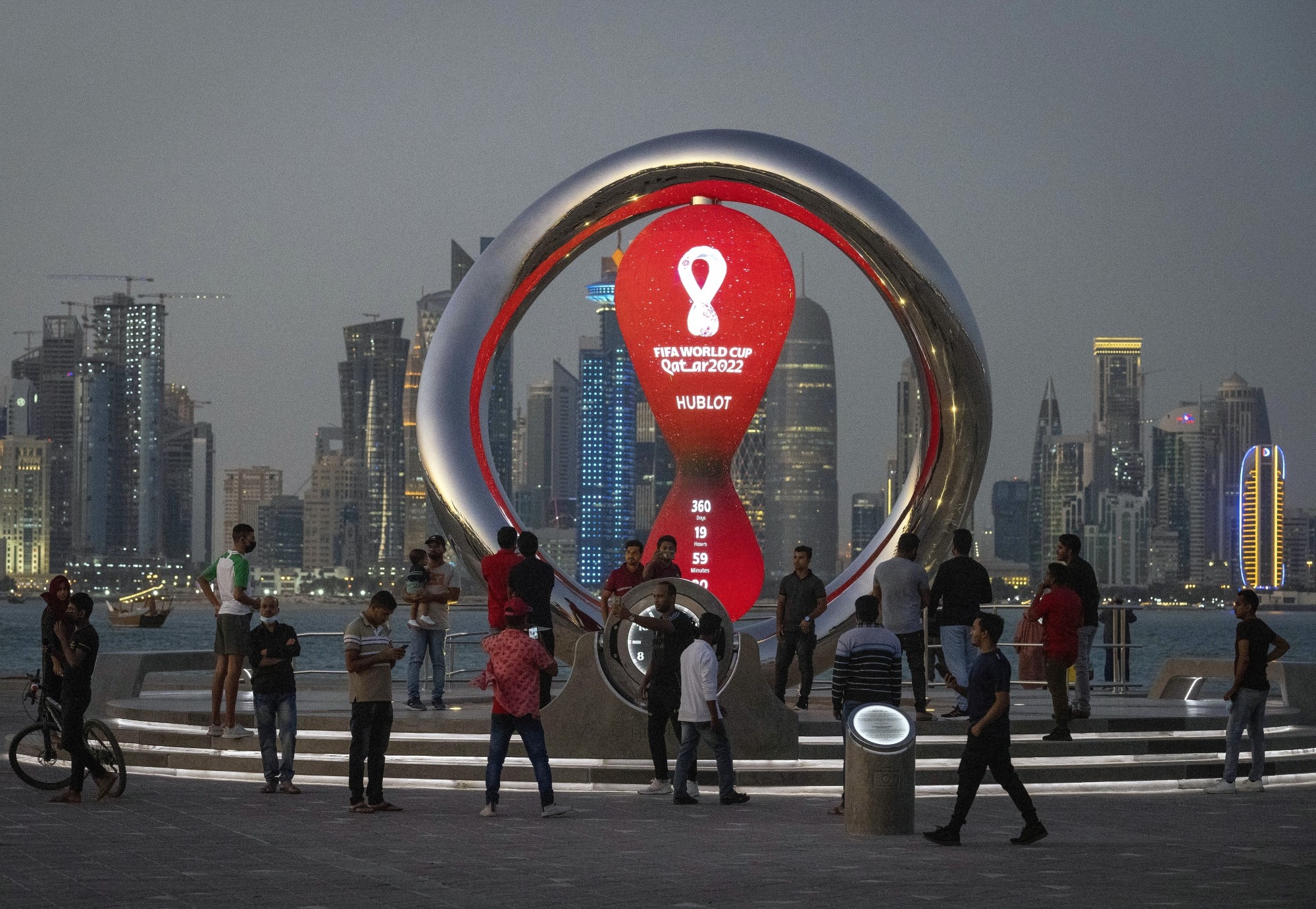 People gather around the official countdown clock showing remaining time until the kick-off of the World Cup 2022, in Doha, Qatar. Photo: AP