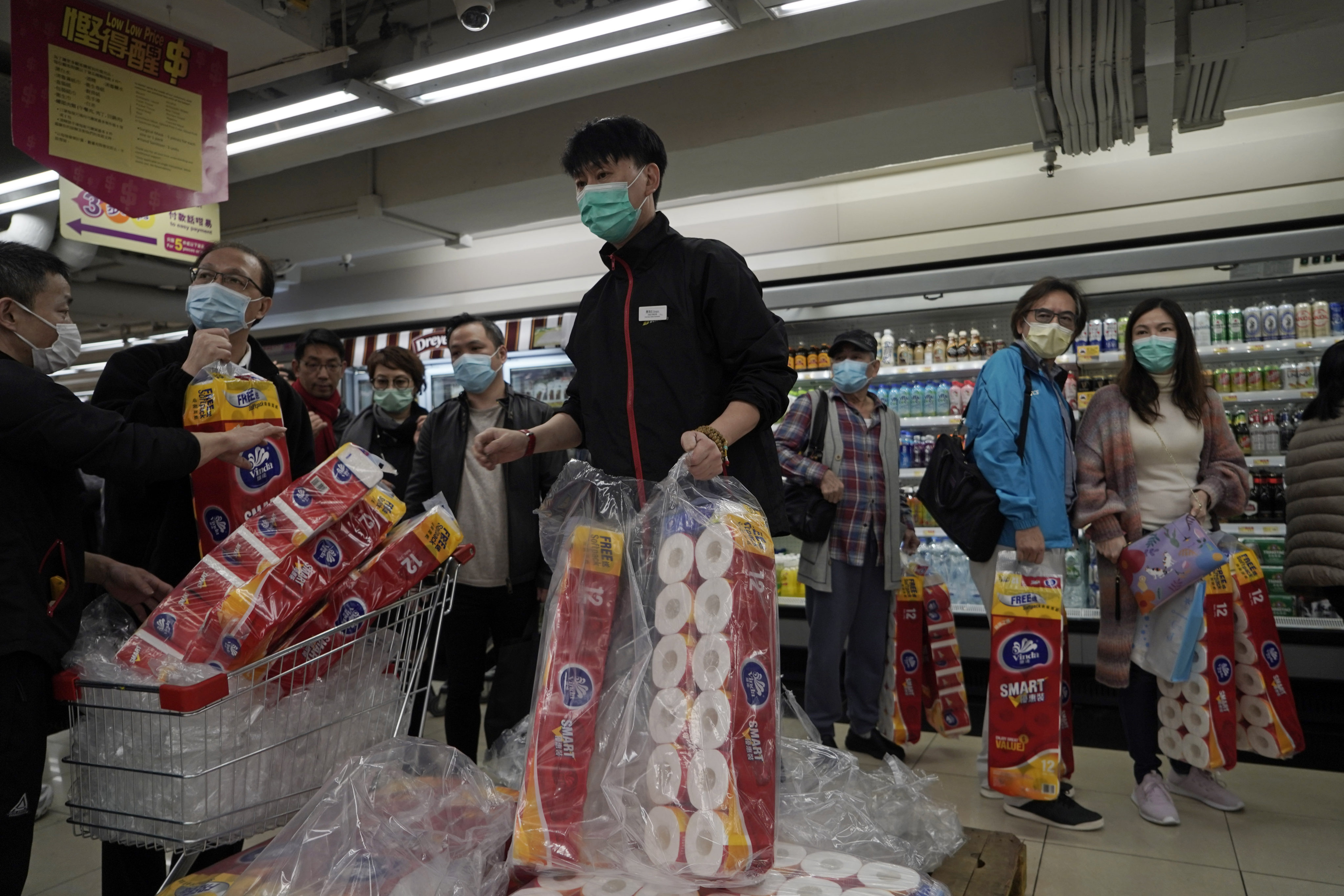 Customers queue to buy toilet paper in a supermarket in Hong Kong on February 14, 2020, a pandemic phenomena that led to widespread shortages in the city. Photo: AP