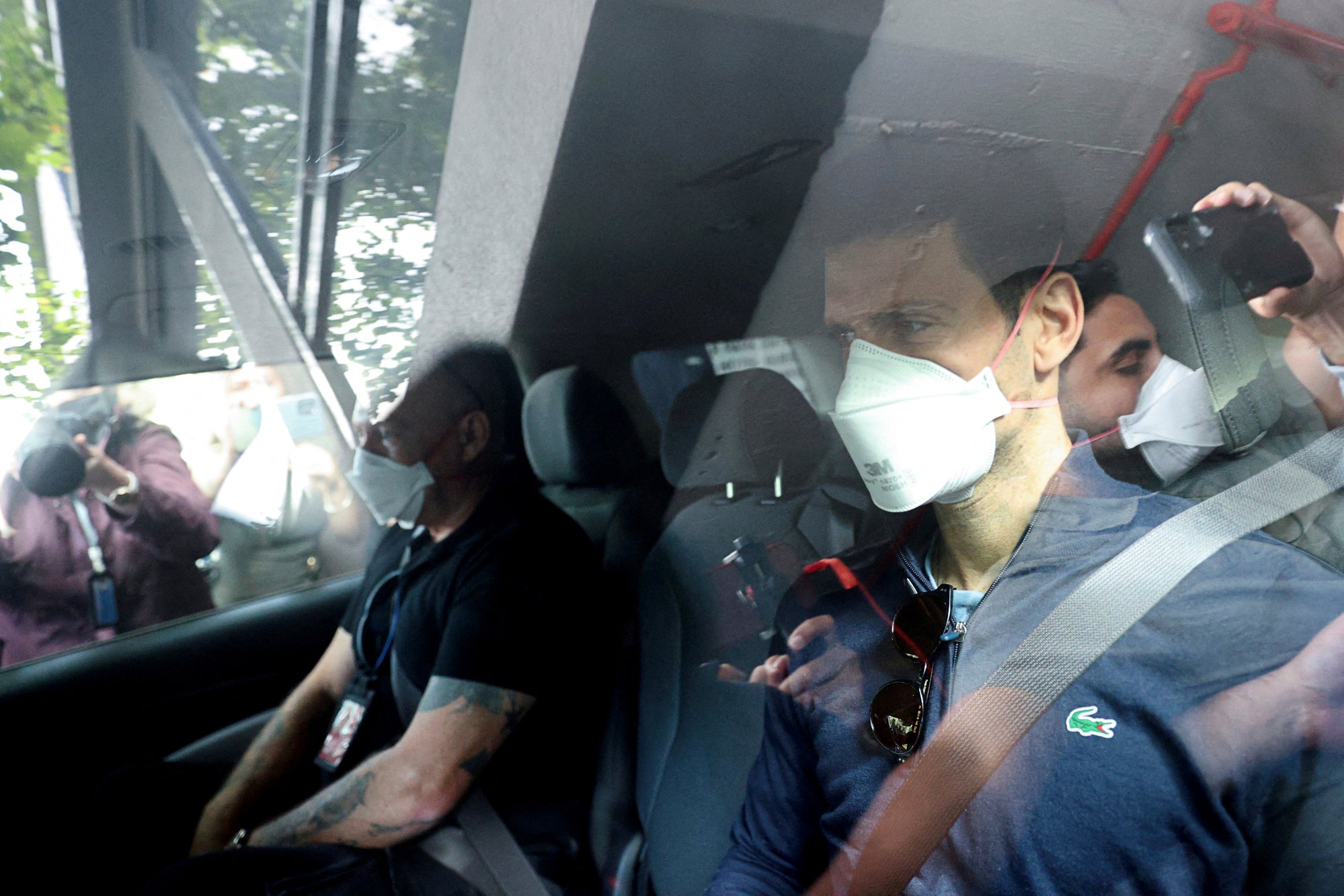 Novak Djokovic departs the Park Hotel while under immigration detention before the 2022 Australian Open. Photo: Reuters