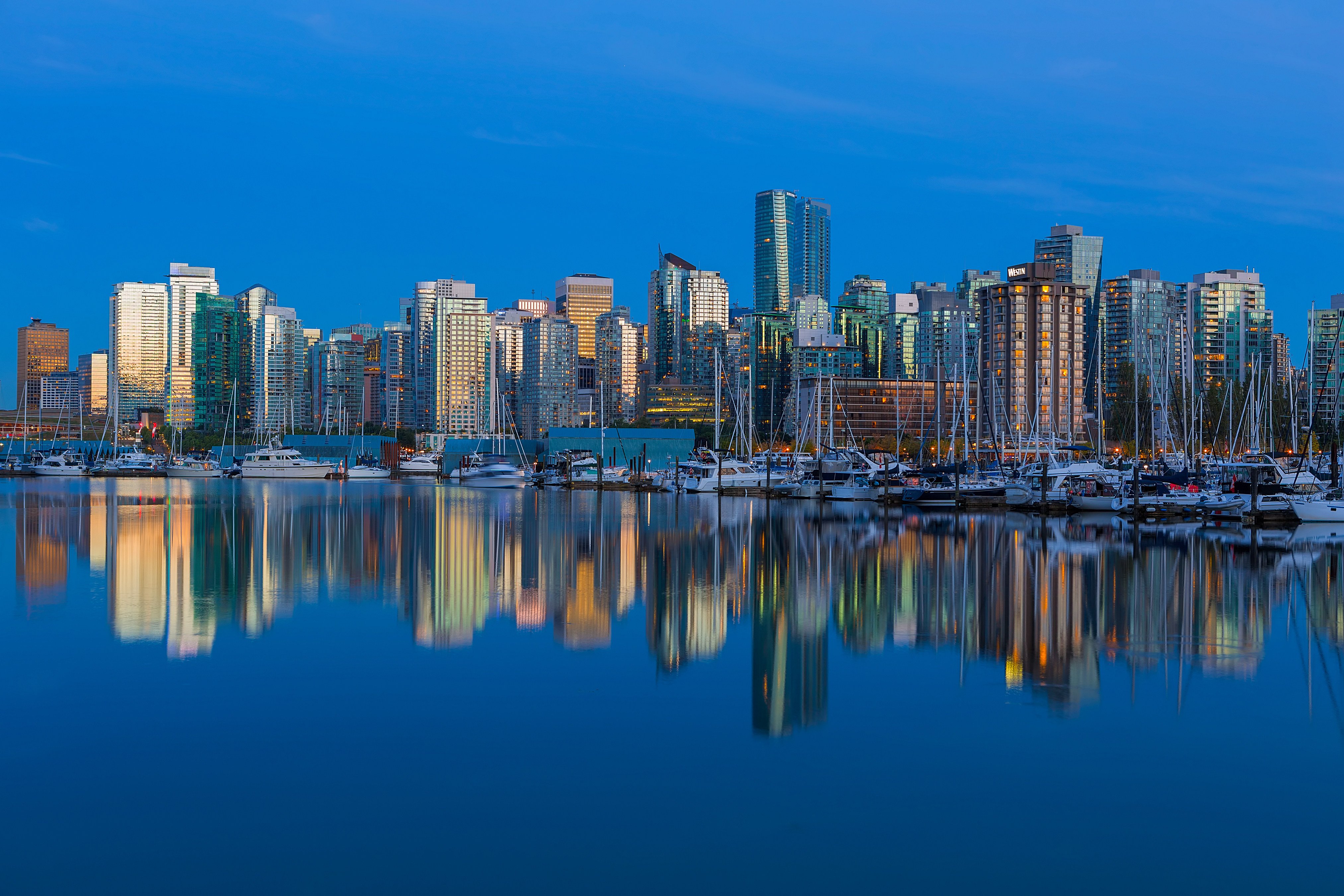 Vancouver, British Columbia’s skyline and reflection by the marina. The city has seen a bump in Hongers immigrating there, reversing recent trends. Photo: Shutterstock