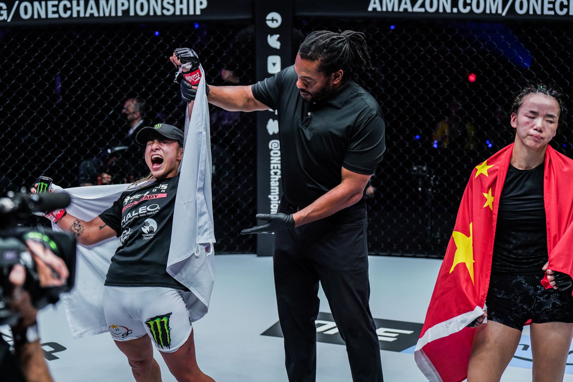 Itsuki Hirata is announced as the winner of her atomweight with Lin Heqin.