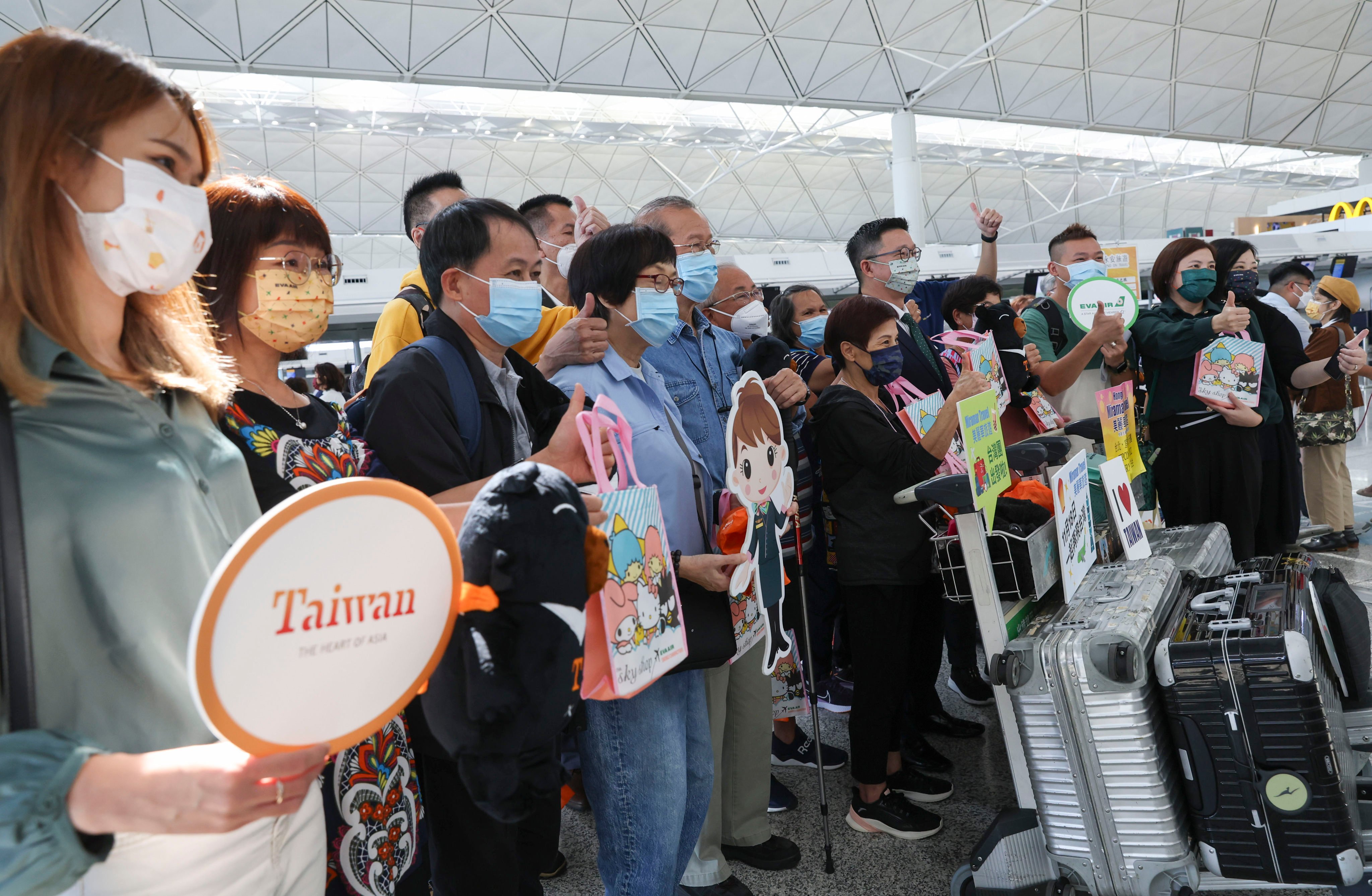 Passengers pose for a picture at the EVA Air counter at Hong Kong International Airport. Photo: Yik Yeung-man