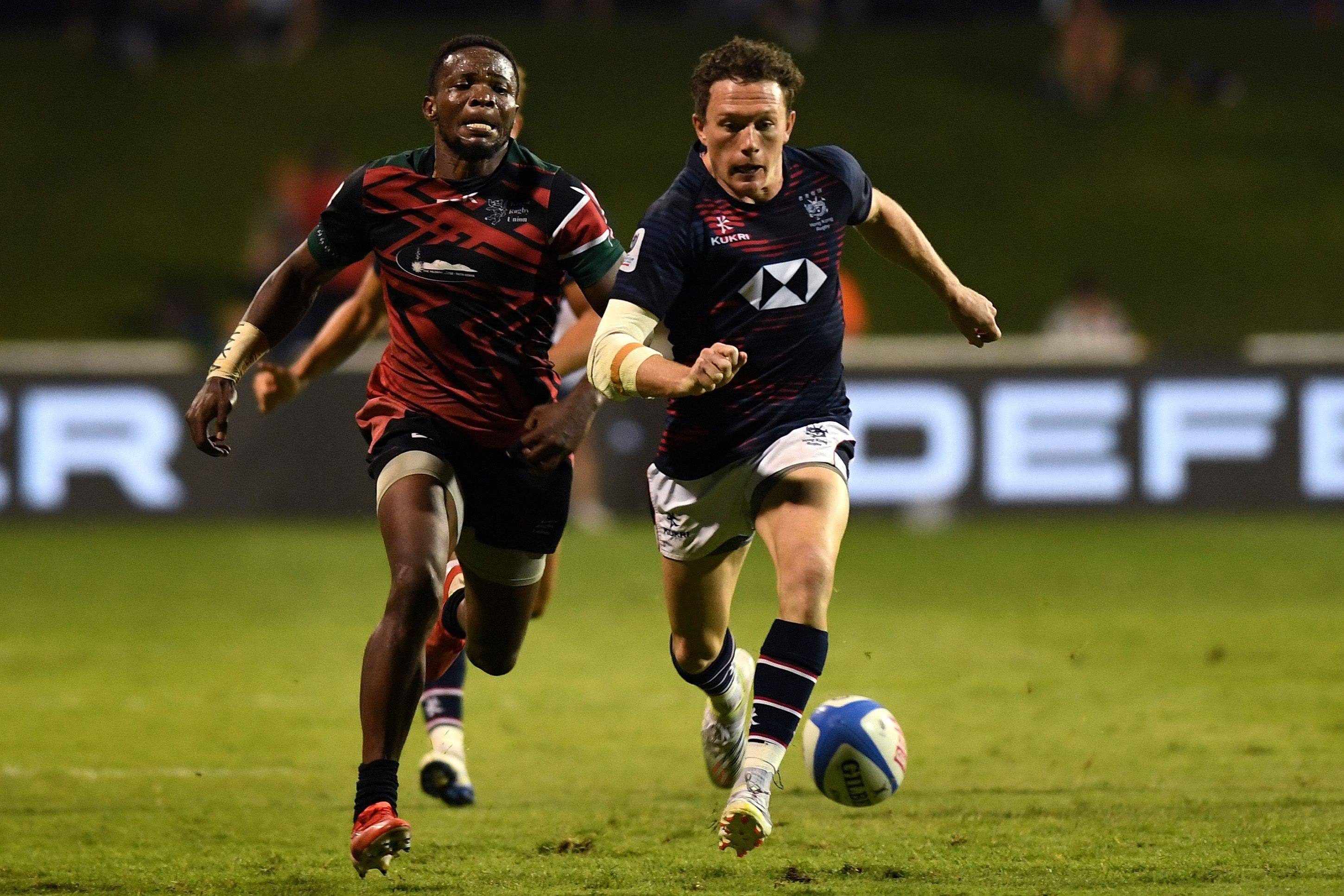 Jack Neville of Hong Kong and Bryceson Adaka of Kenya chase down a loose ball during the RWC 2023 Final Qualification Tournament match at The Sevens Stadium on November 18, 2022 in Dubai, United Arab Emirates. Photo: World Rugby via Getty Images