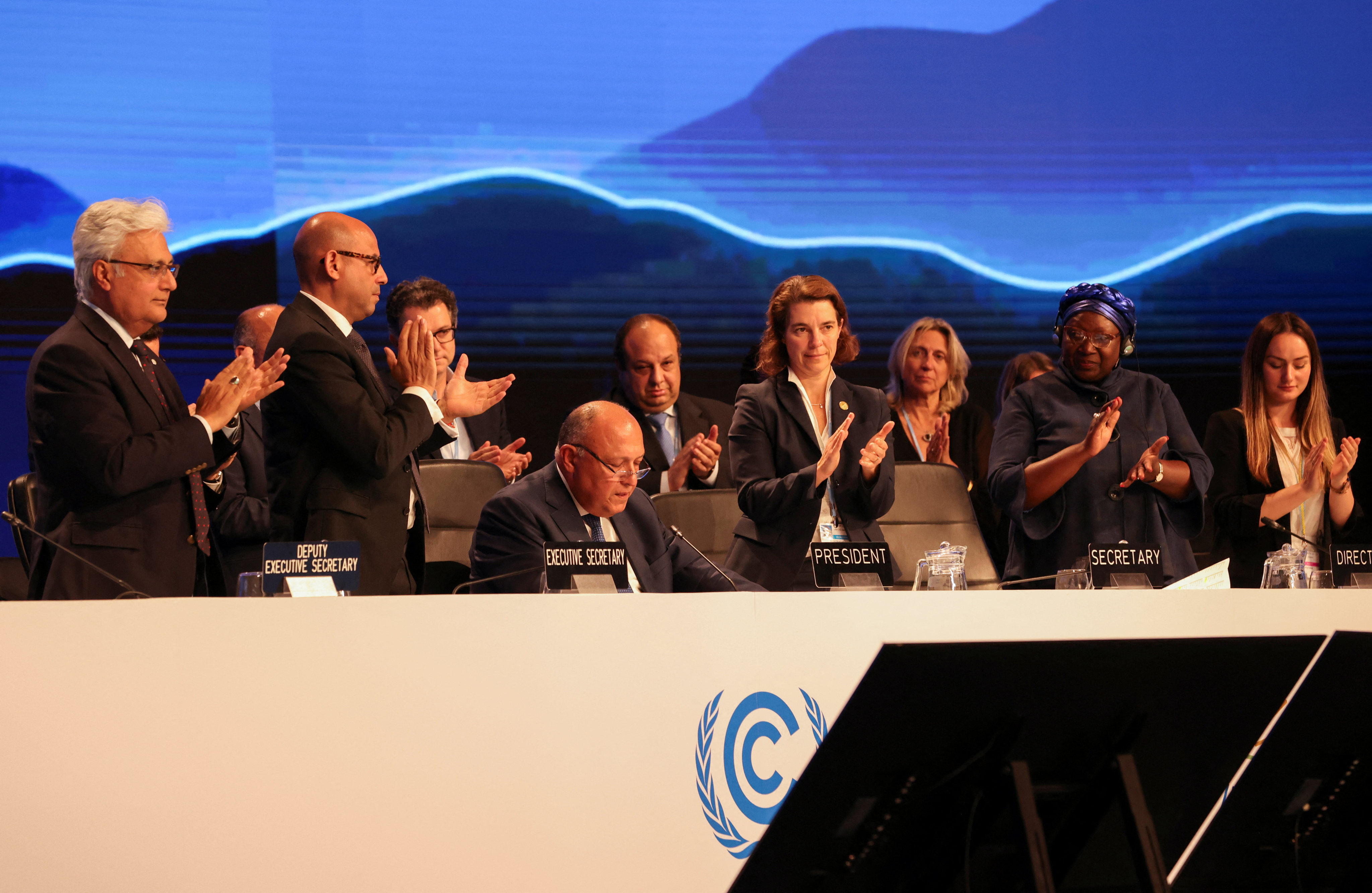 Delegates applauds as COP27 President Sameh Shoukry delivers a statement during the closing plenary at the COP27 climate summit in Red Sea resort of Sharm el-Sheikh, Egypt. Photo: Reuters