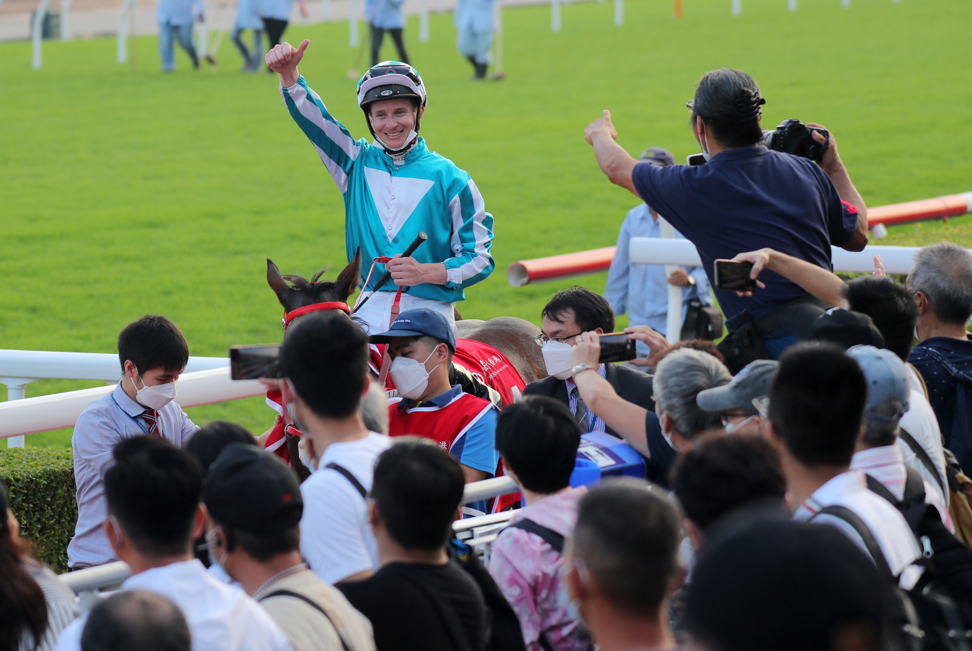 James McDonald receives the acclaim of the crowd aboard Jockey Club Cup victor Romantic Warrior.