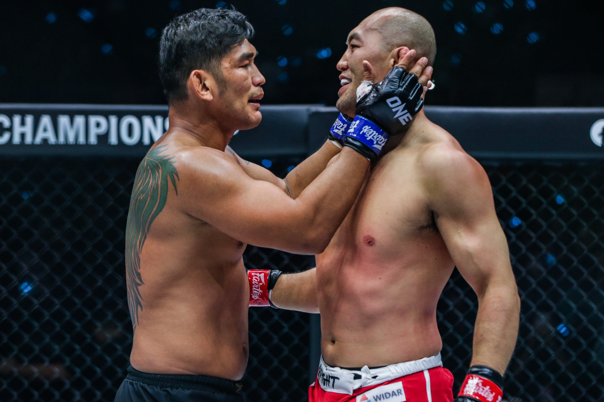 Aung La N Sang consoles Yushin Okami after defeating him.