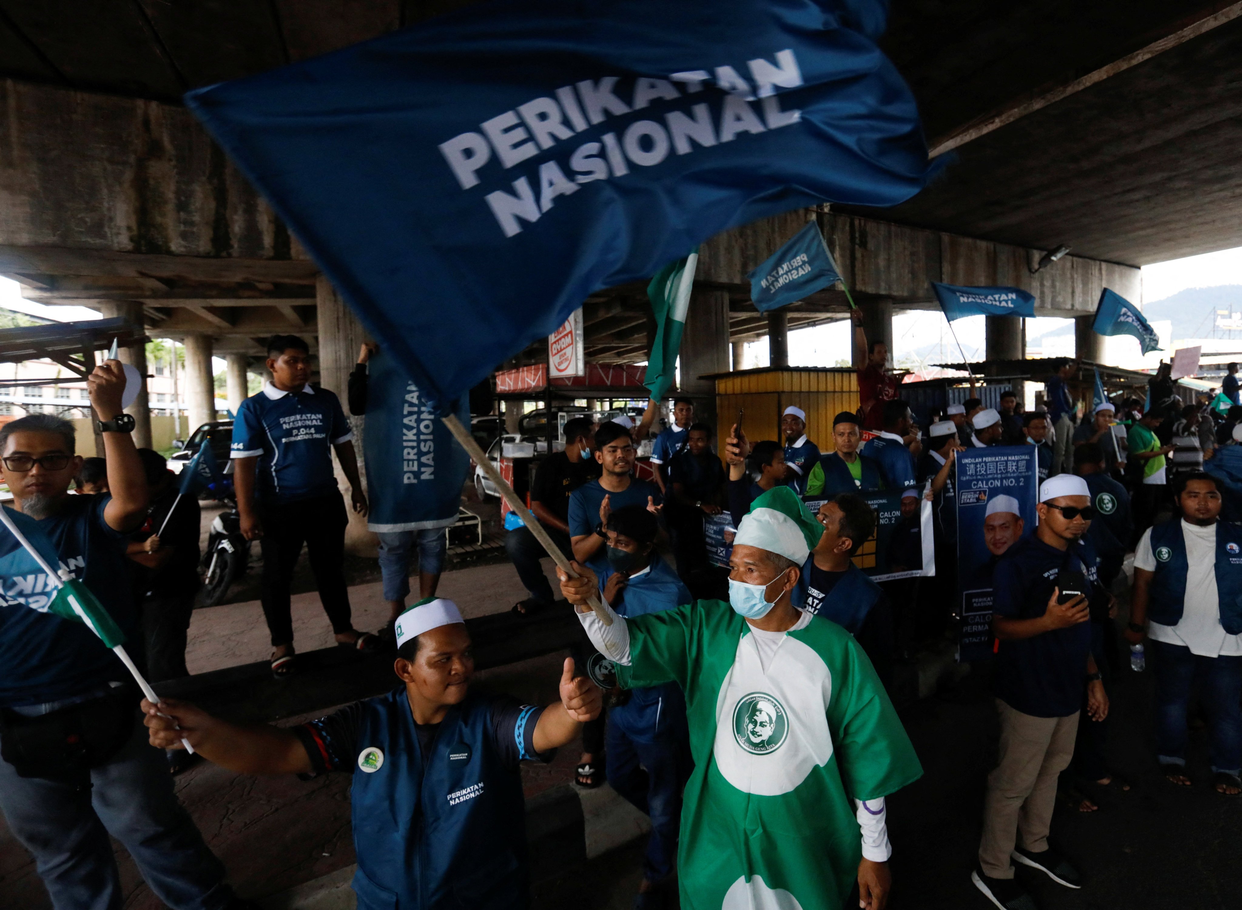 Perikatan Nasional supporters in Penang wave party flags on the eve of Malaysia’s general election. Photo: Reuters