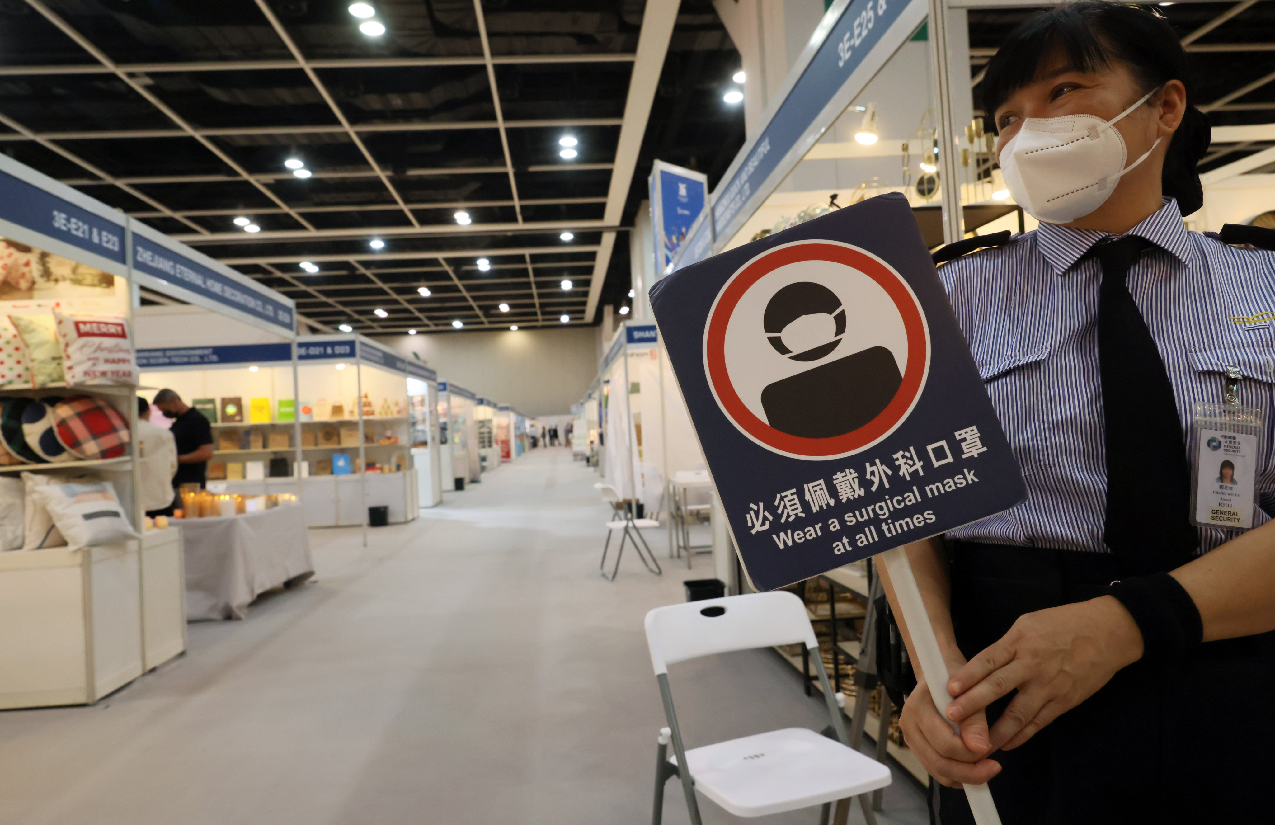A security staff carries a placard to remind guests to wear a mask at all times at Mega Show at the Hong Kong Convention and Exhibition Centre in Wan Chai on November 15. The four-day international sourcing trade fair features items mainly produced in Asia for international buyers, including houseware, toys and baby products. Photo: Dickson Lee
