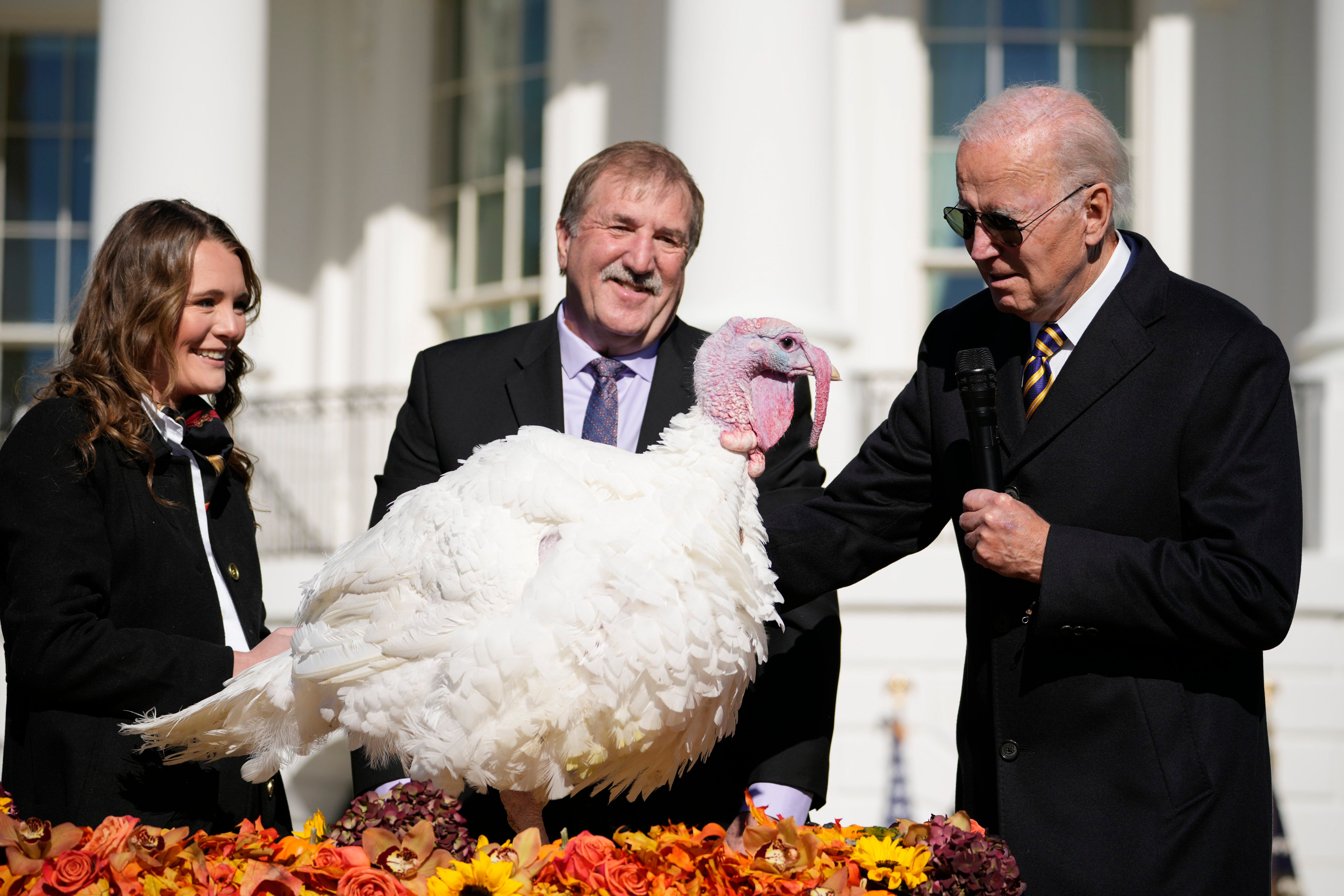 US President Joe Biden pardons Chocolate, the national Thanksgiving turkey, at the White House on Monday. He is joined by Ronald Parker, chairman of the National Turkey Federation, and Alexa Starnes, daughter of the owner of Circle S Ranch. Photo: AP