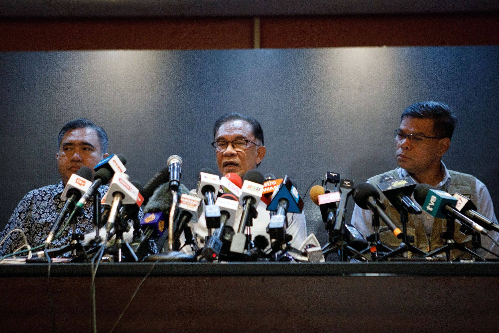 Anwar Ibrahim, Malaysia’s opposition leader (centre) speaks during a news conference on November 21. Anwar, who has come tantalisingly close to leading Malaysia during his tumultuous political career, is suddenly on the cusp of clinching the top job but a final hurdle stands in his way. Photo: Bloomberg