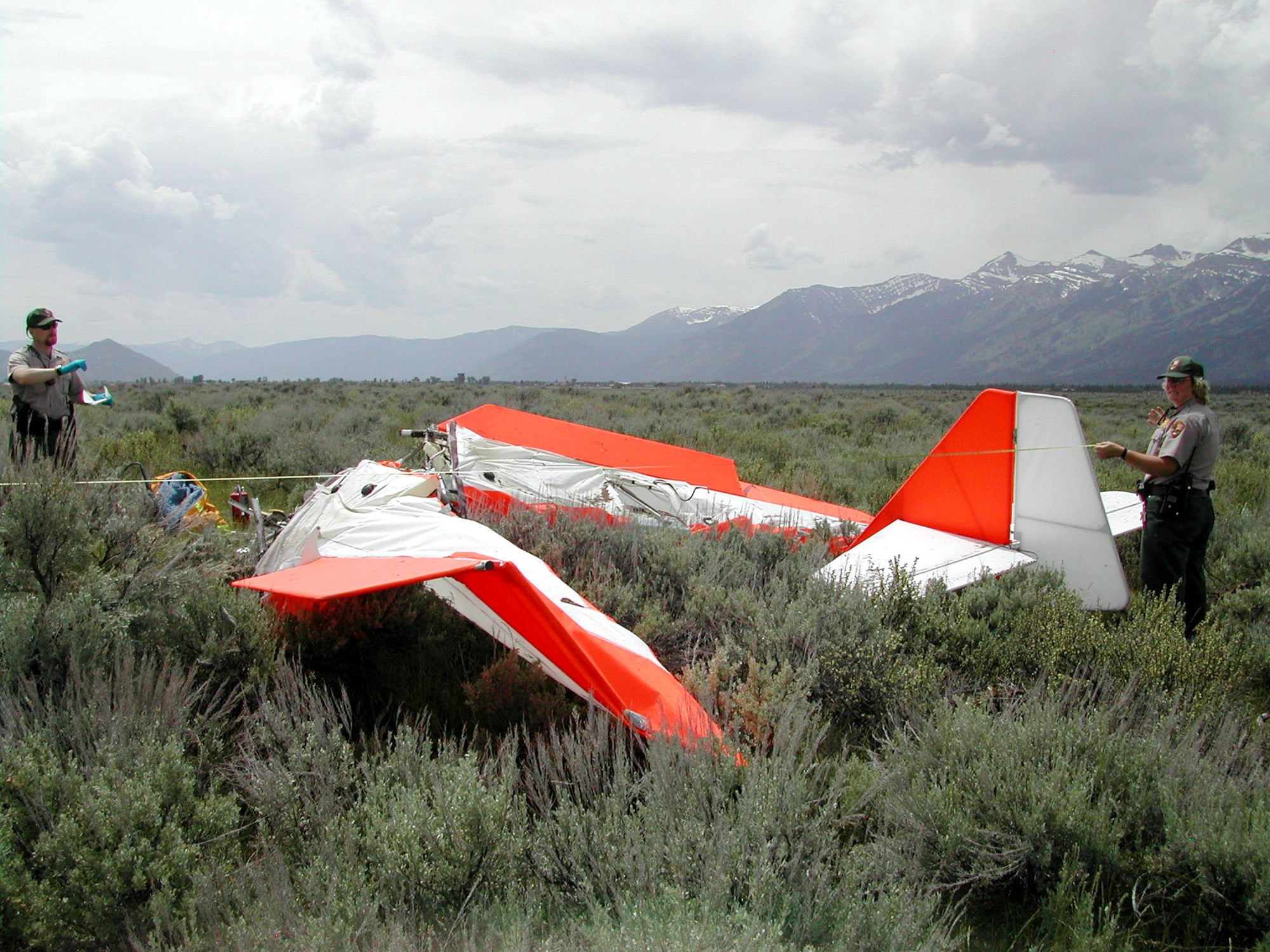 National Park rangers examine the debris from the ultralight aircraft crash that killed John Walton in 2005. Photo: Getty Images