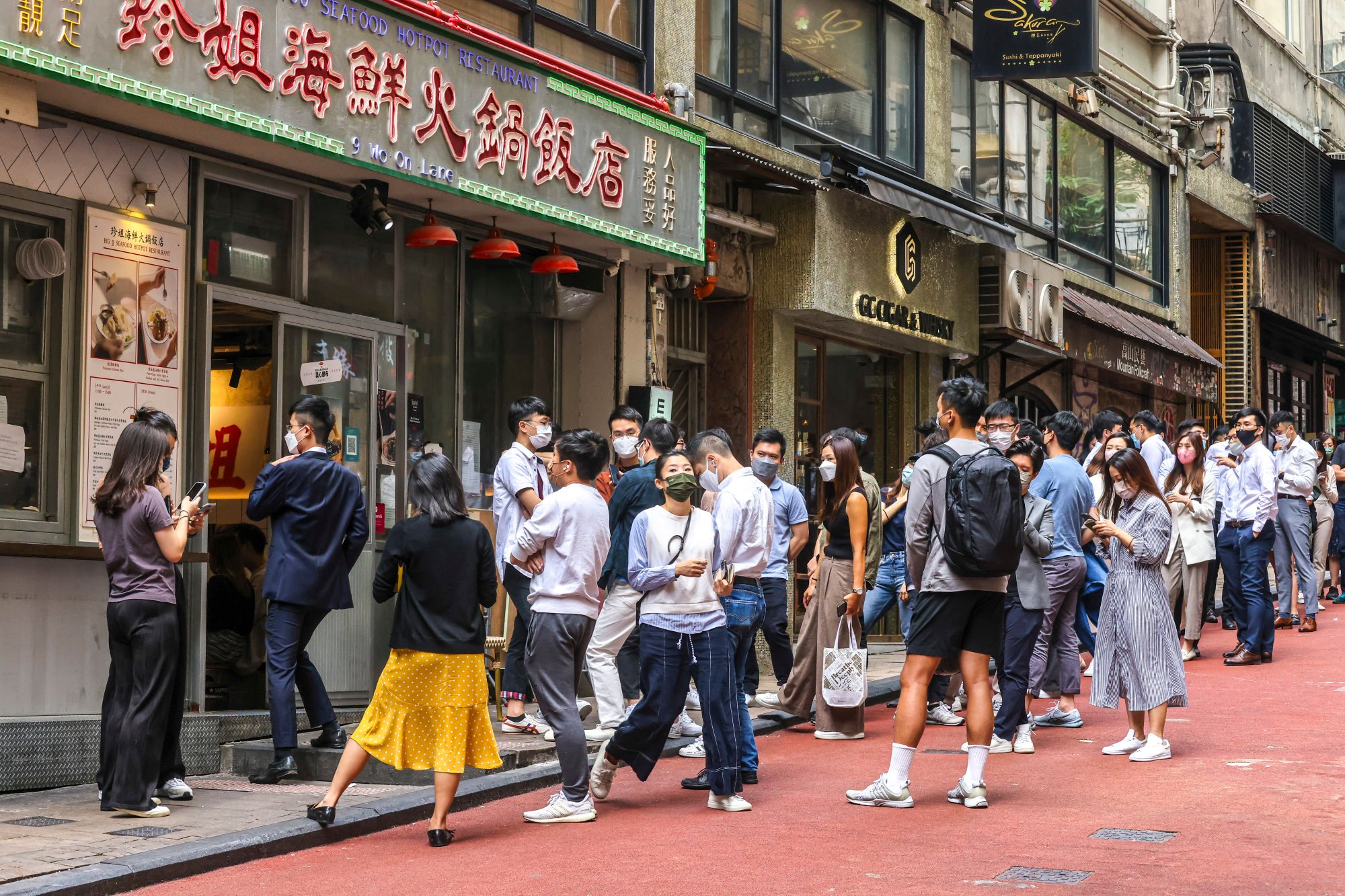 Diners queue outside a restaurant in Hong Kong’s Lan Kwai Fong area on October 20, 2022. Photo: SCMP / Jonathan Wong