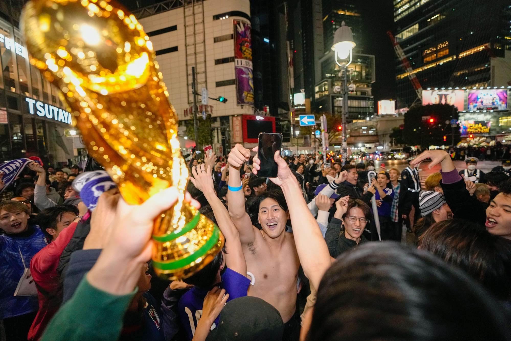 People gathered in Tokyo in the early hours of Thursday to celebrate Japan’s 2-1 victory over Germany. Photo: Kyodo