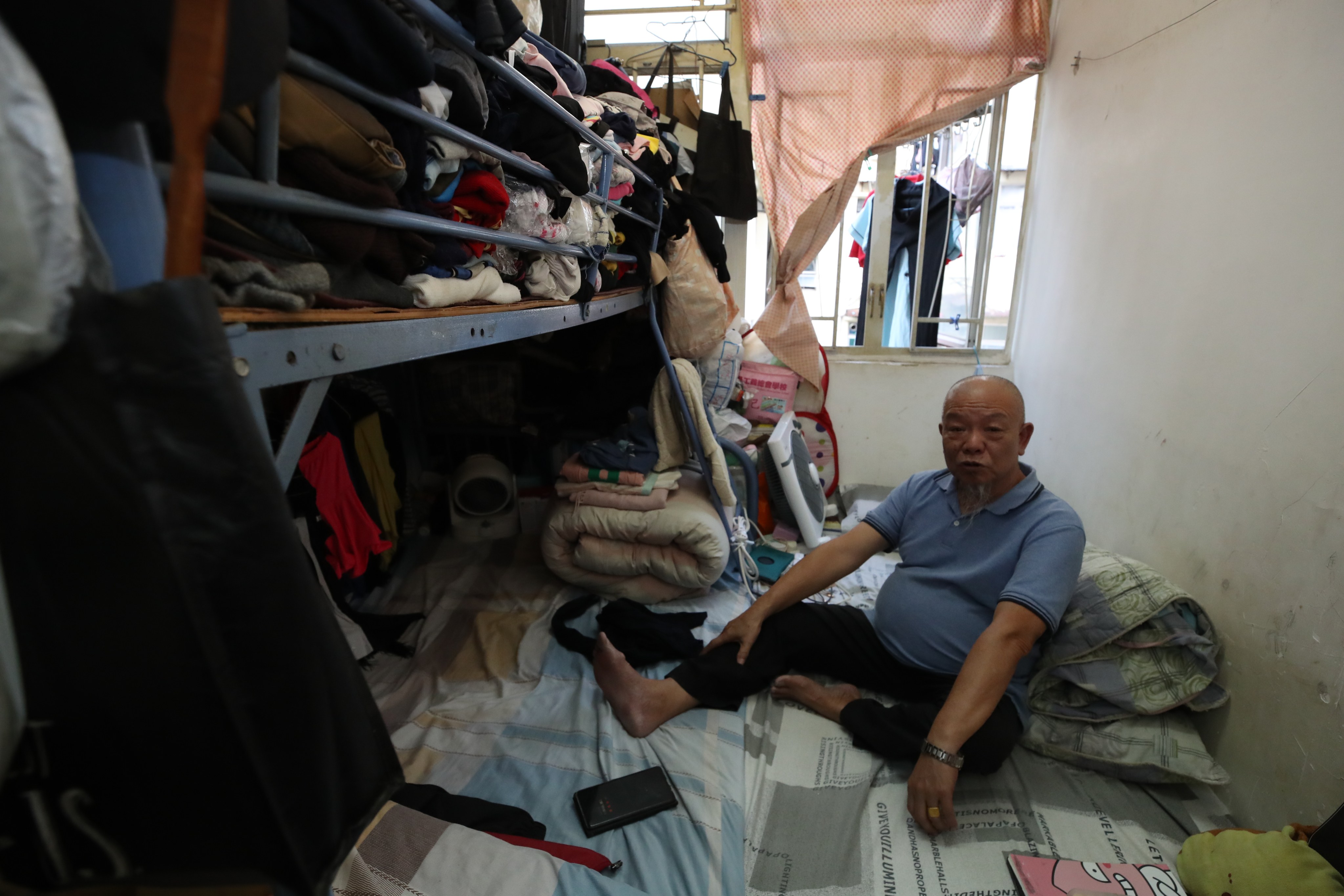 Chan Chuen-bui in the subdivided flat that is home to him, his wife and daughter. Photo: Edmond So
