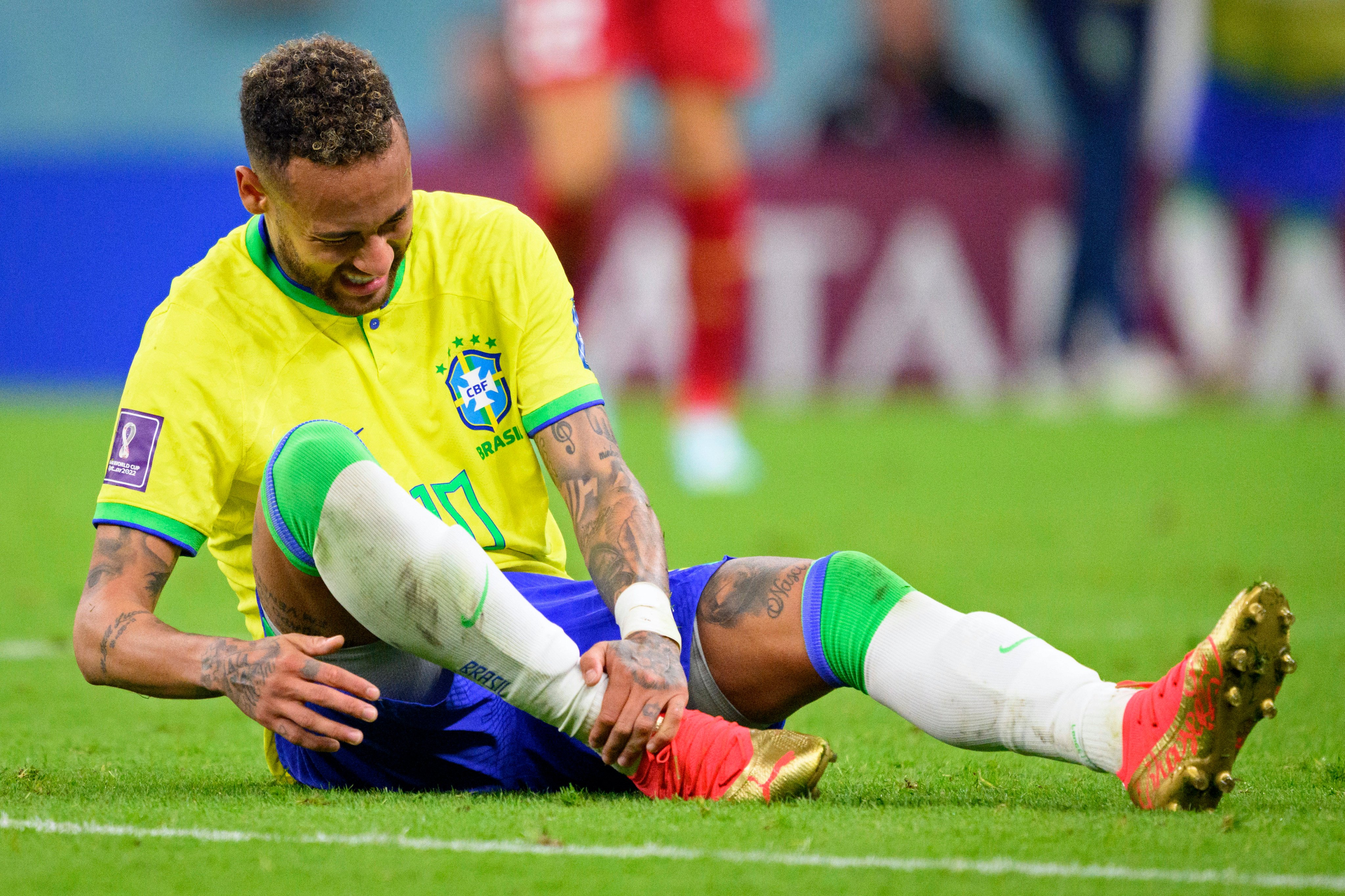 Brazil’s Neymar grabs his ankle after an injury during the World Cup group G match against Serbia at the the Lusail Stadium in Qatar. Photo: AP