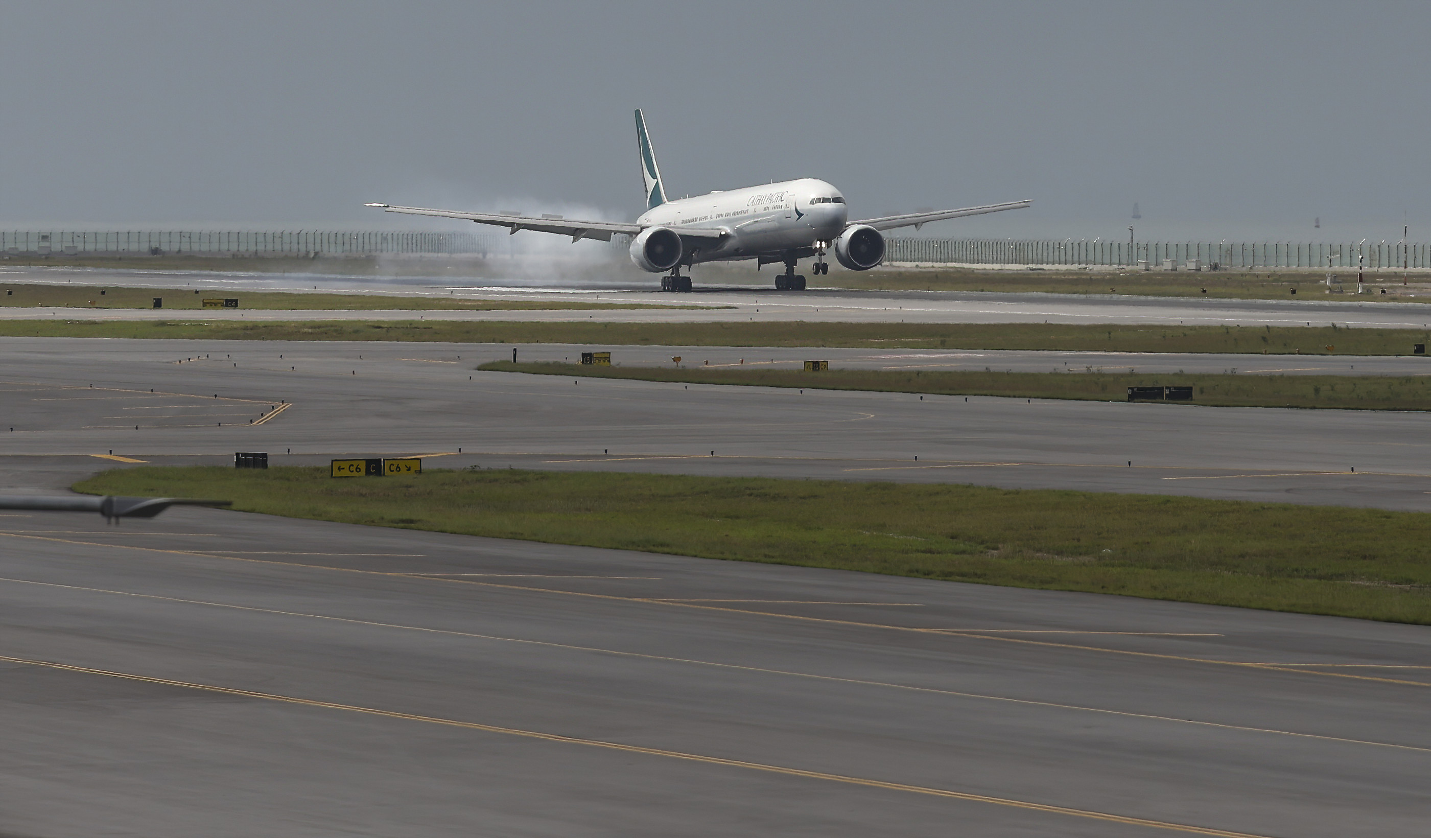 A Cathay Pacific flight touches down after the official opening of the airport’s third runway. Photo: Yik Yeung-man