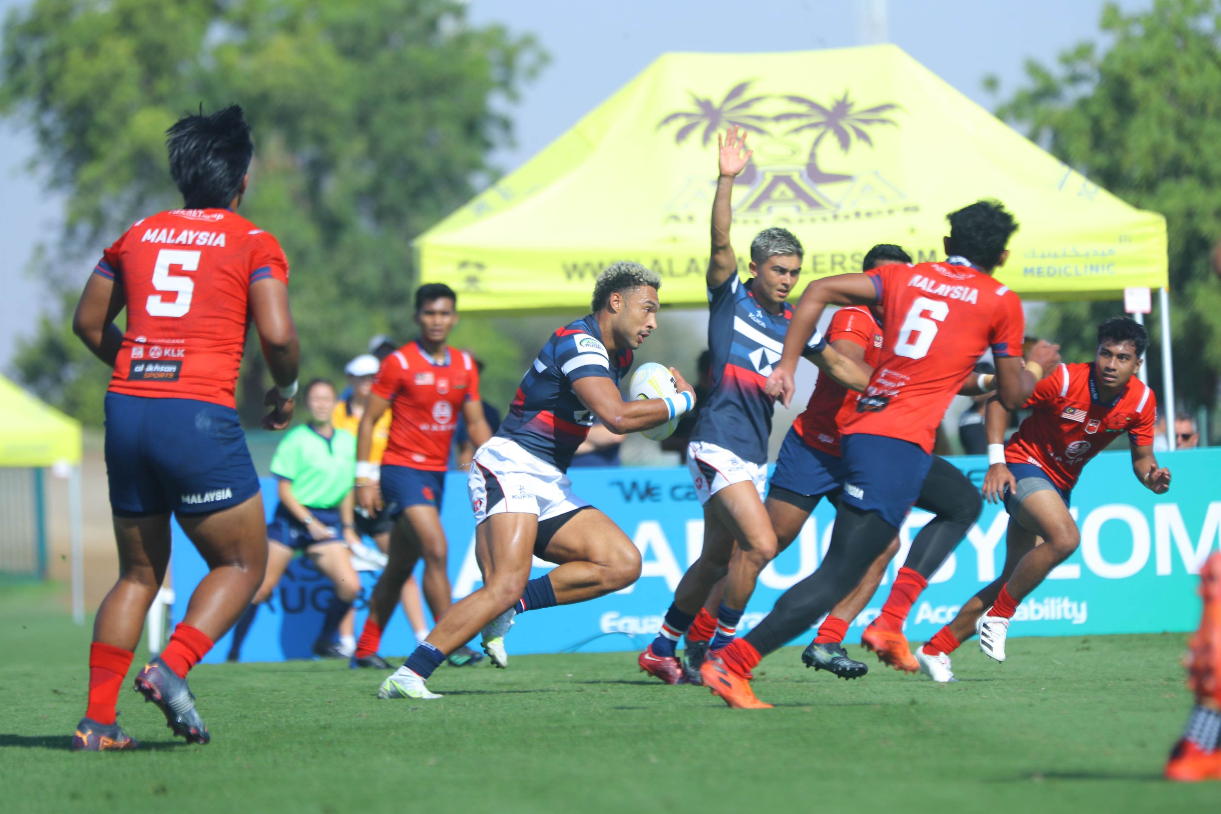 Max Denmark puts Malaysia on the back foot at the Asia Rugby Sevens Series in the UAE. Photos: Asia Rugby