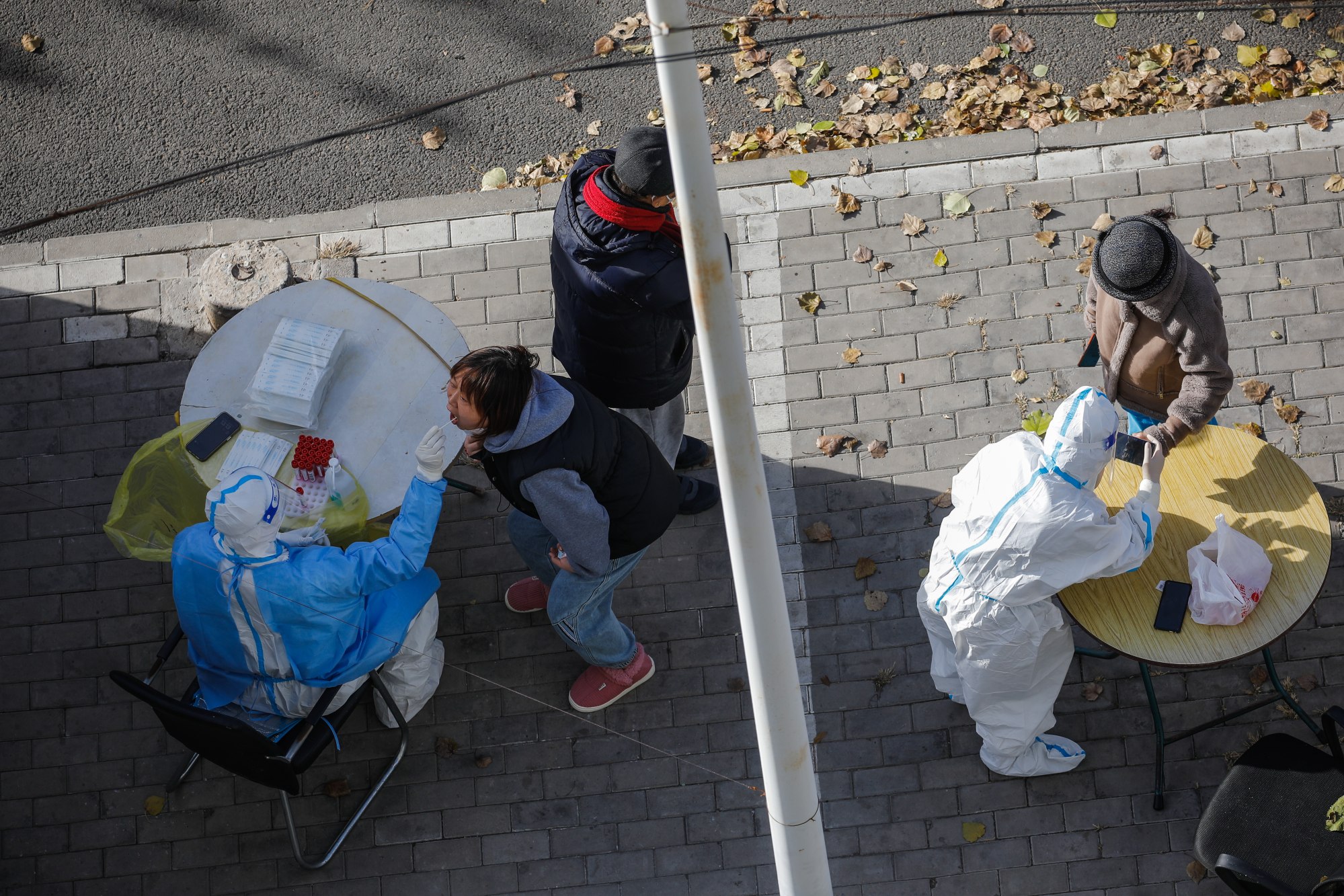 A woman undergoes a COVID-19 test in Beijing, China. Photo: EPA-EFE