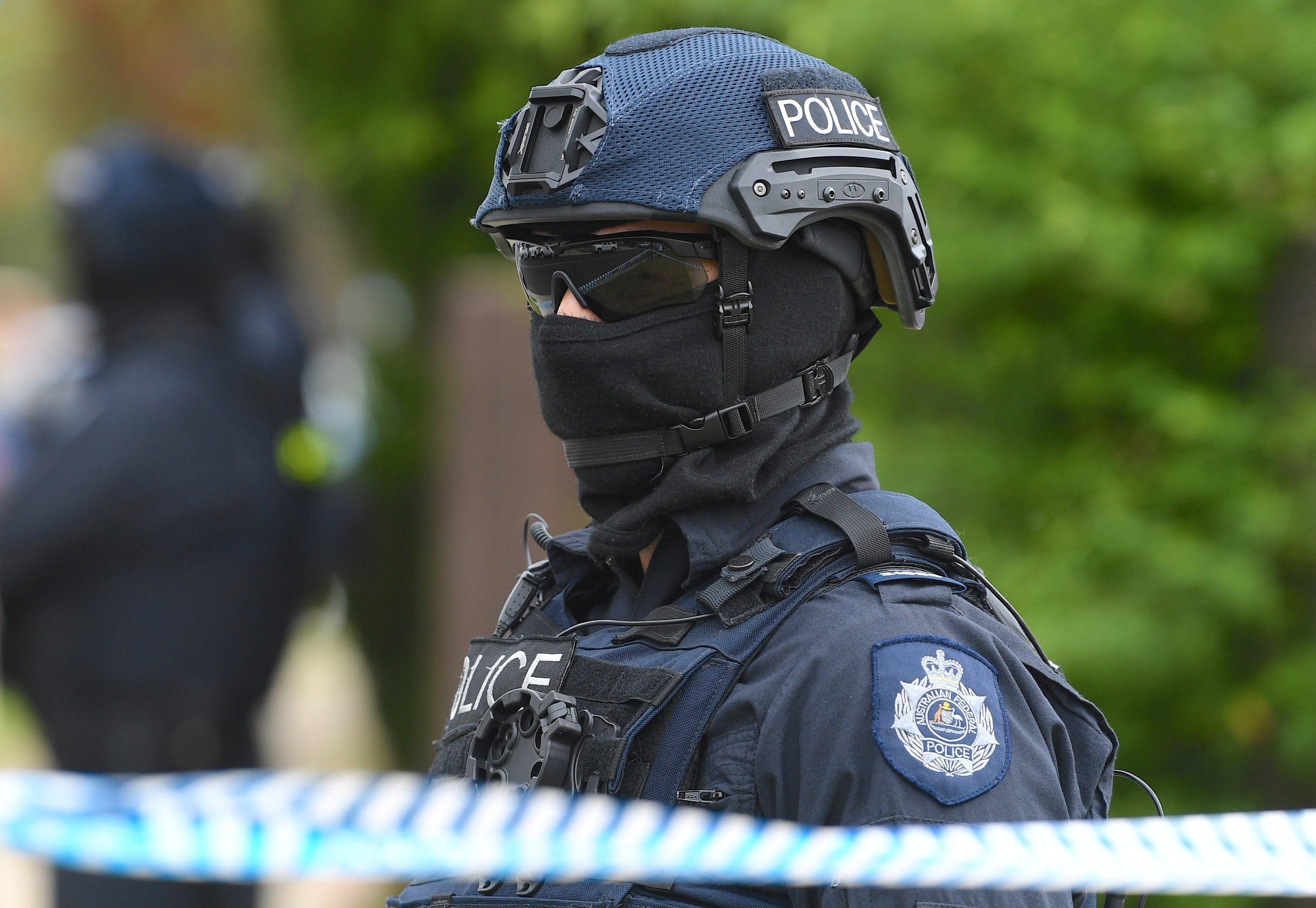 Australian police officers stand outside a property in a suburb of Melbourne during a counter-terrorism raid in 2018.  Photo: AAP via Reuters