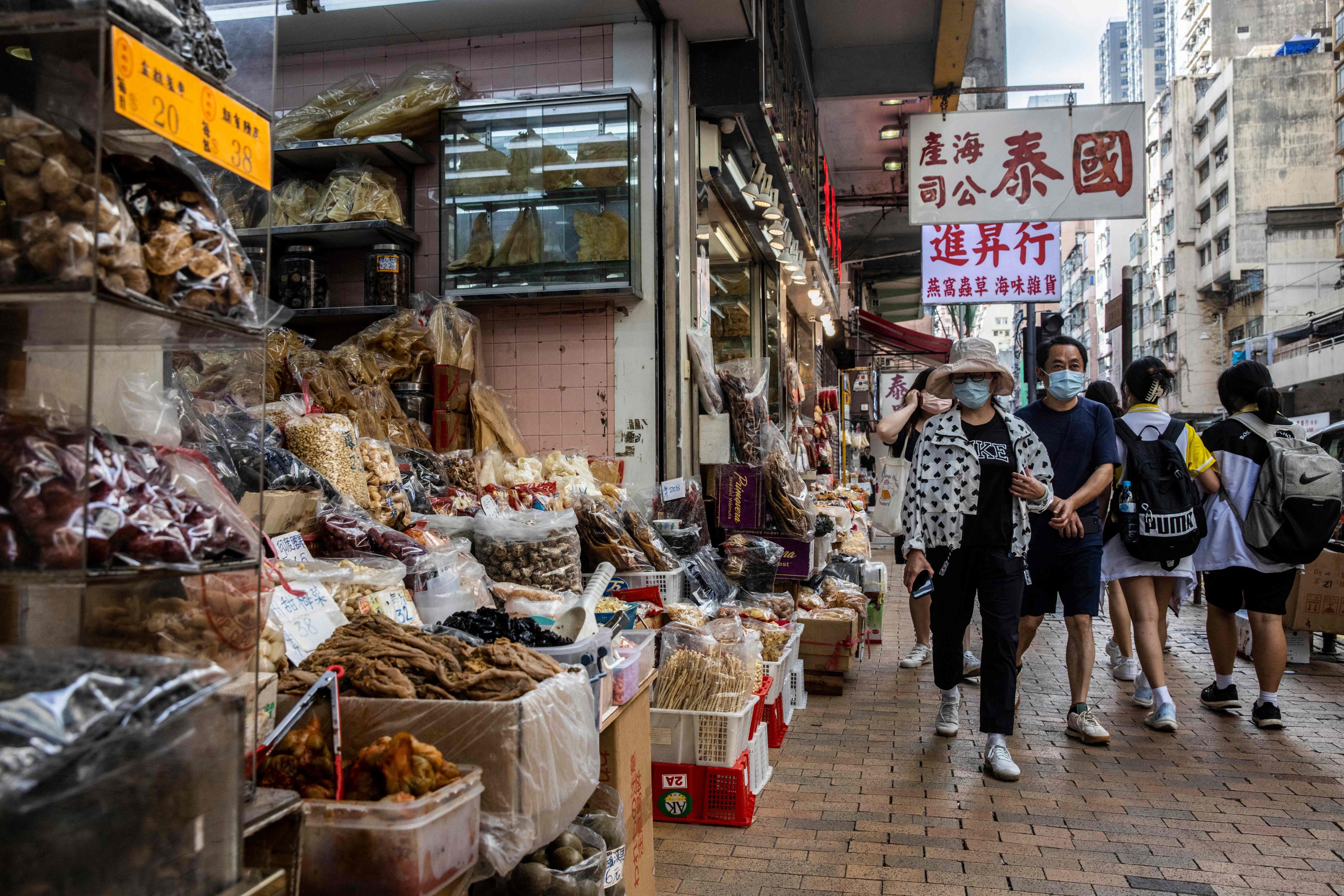 People walk past a shop in Hong Kong selling sharks fin, dried seafood and other products on November 17. Photo: AFP