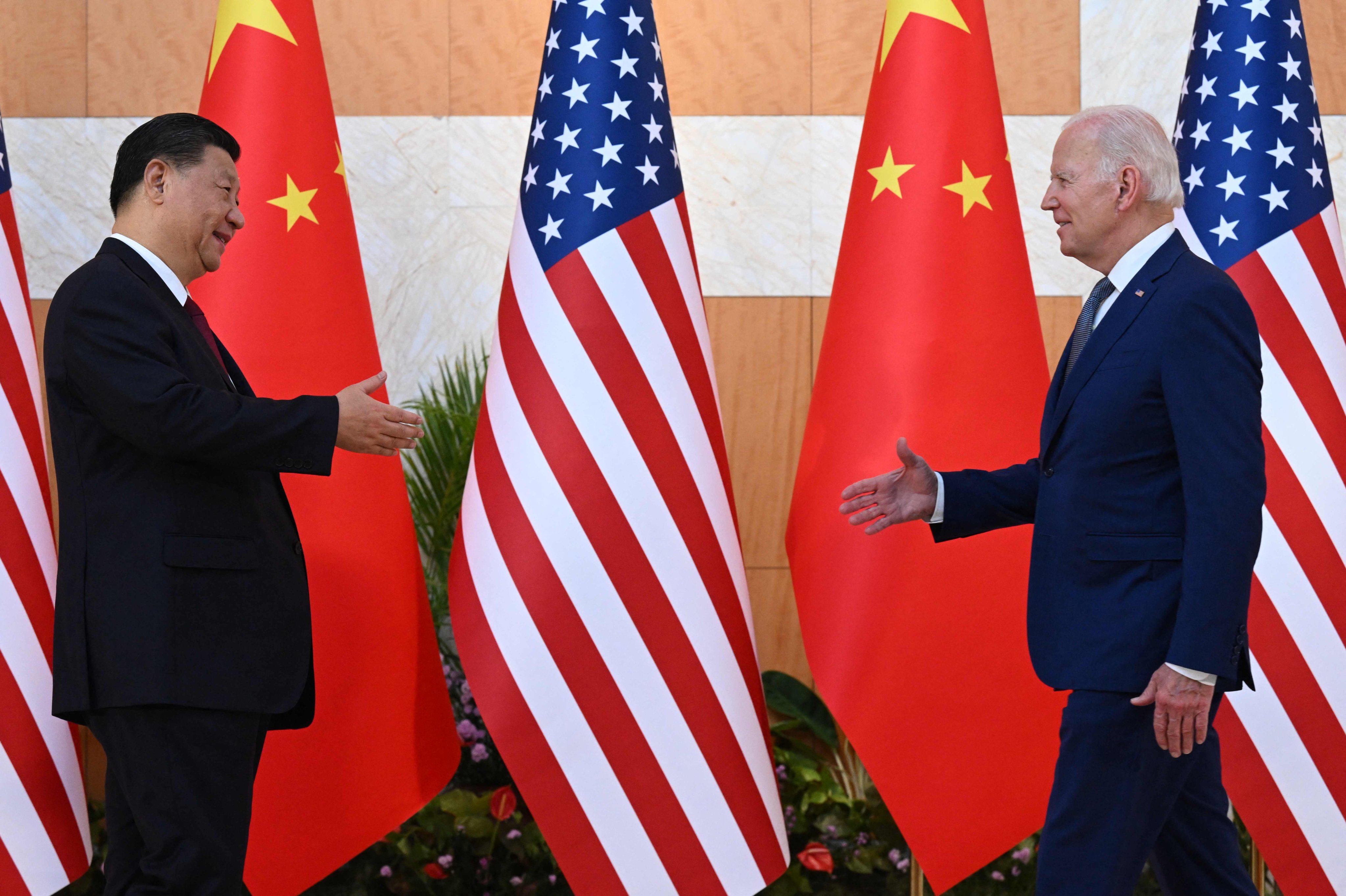 US President Joe Biden and Chinese President Xi Jinping reach out to shake hands as they meet on the sidelines of the G20 Summit in Bali, Indonesia, on November 14. Photo: AFP