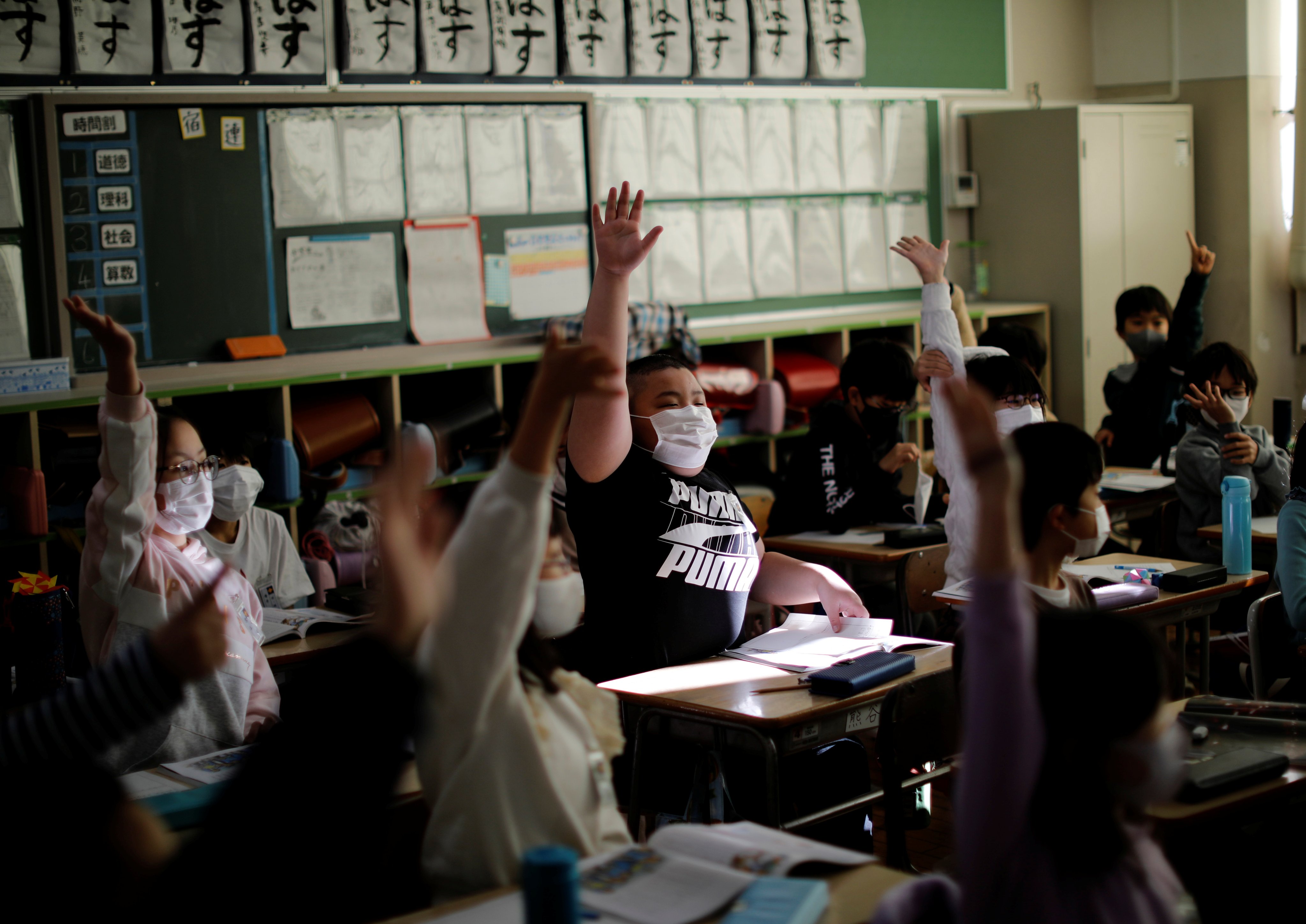 Japan’s education ministry said it would ask schools to proactively get students to remove their masks where they are not necessary. File photo: Reuters