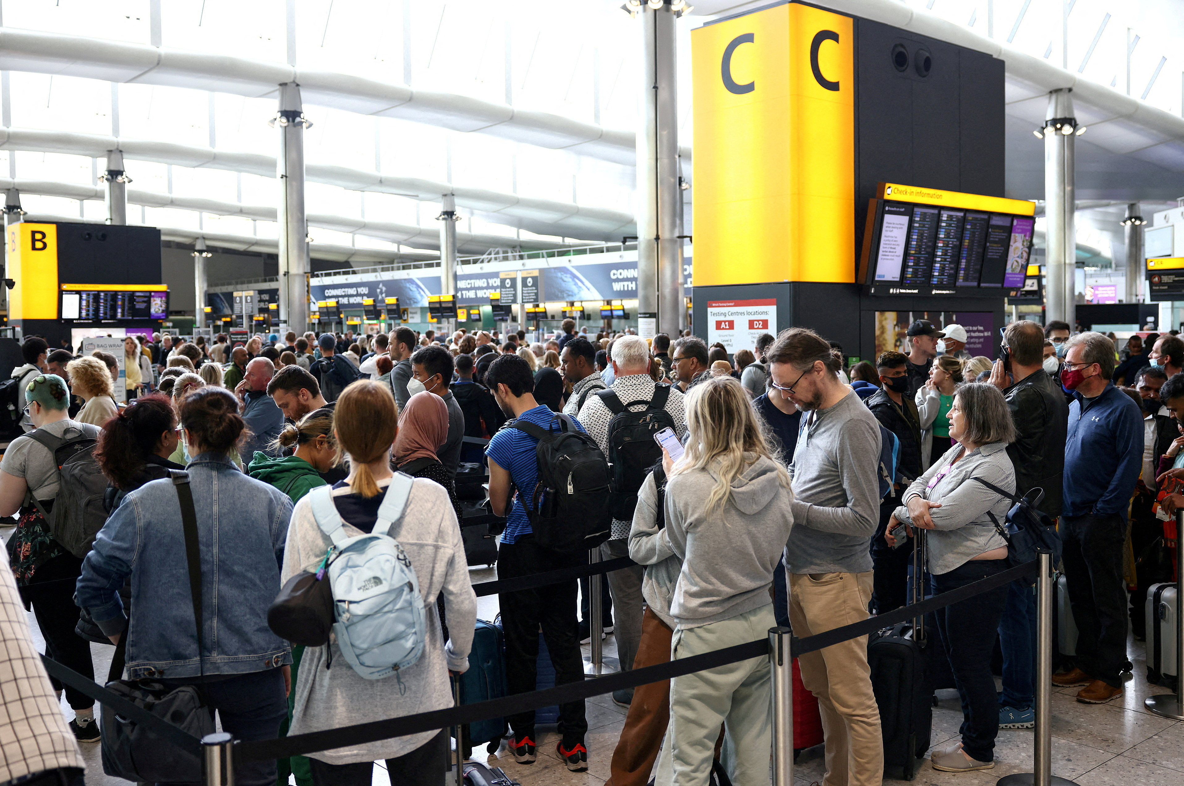 Passengers queue inside Heathrow Airport in London, which will be affected by strikes. Photo: Reuters
