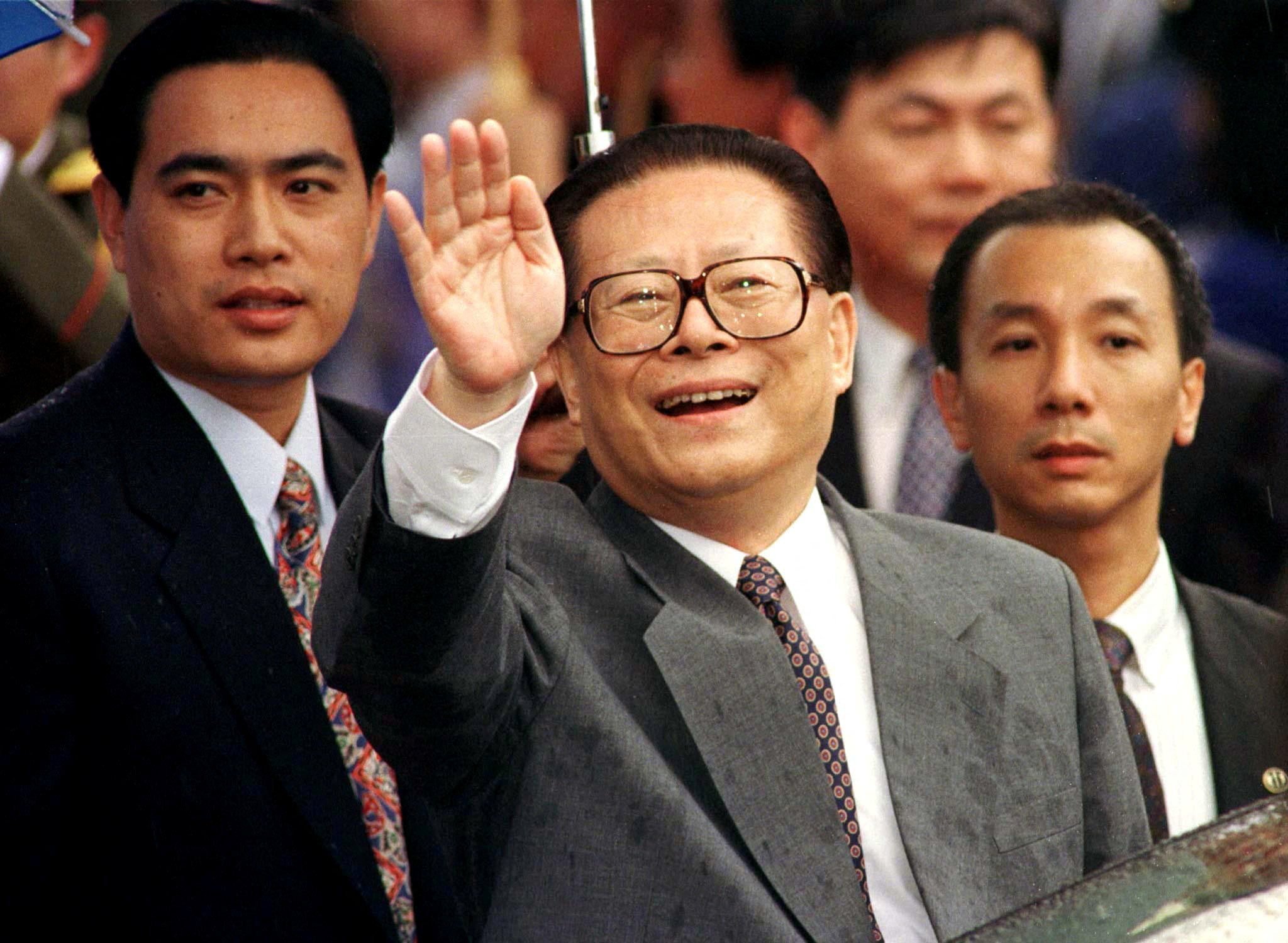 Then president Jiang Zemin smiles through the rain, and waves to a crowd on his arrival in Hong Kong on June 30, 1997. Photo: Reuters