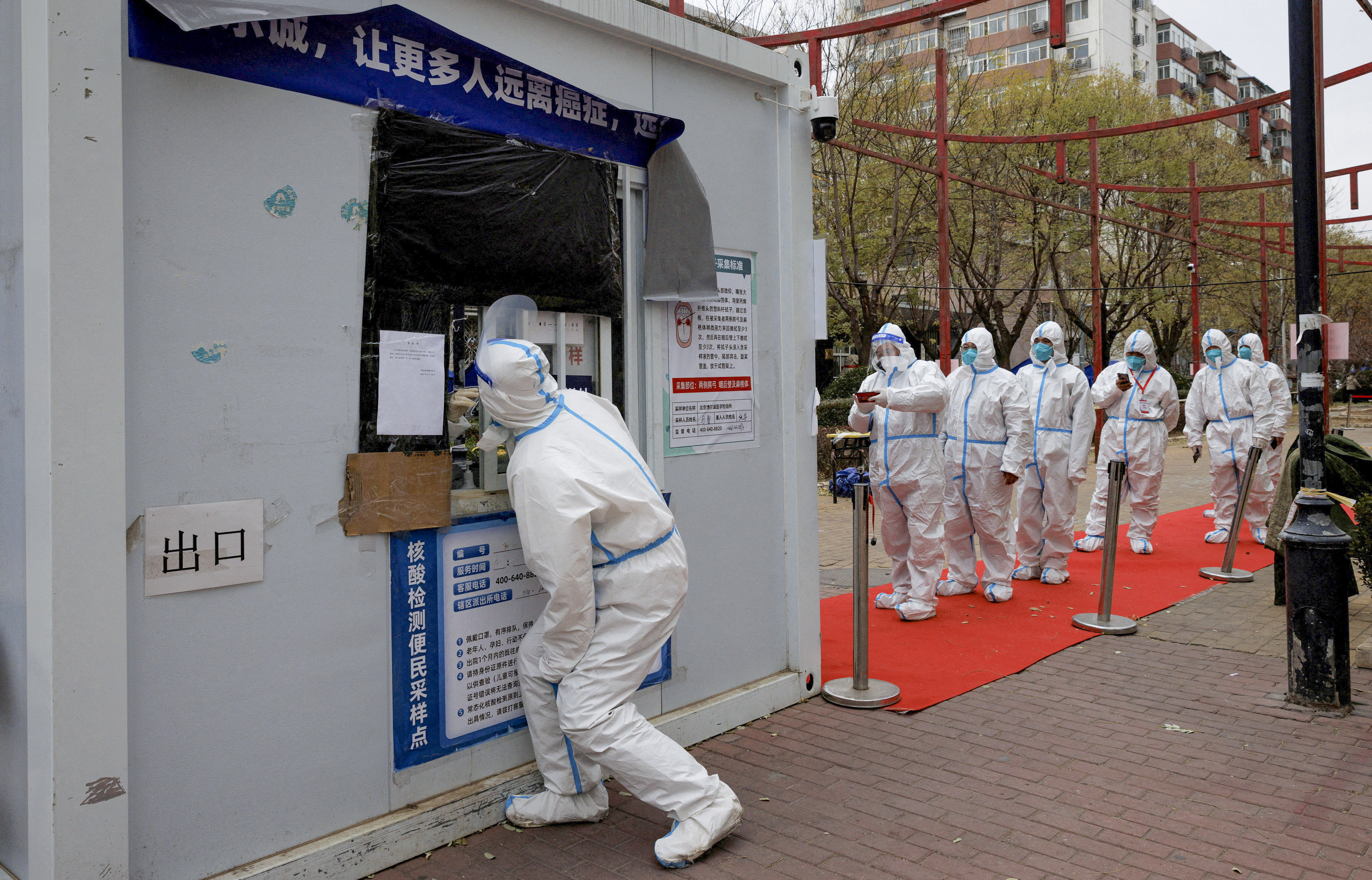 Coronavirus-prevention workers get tested for Covid-19 in Beijing this week. Photo: Reuters