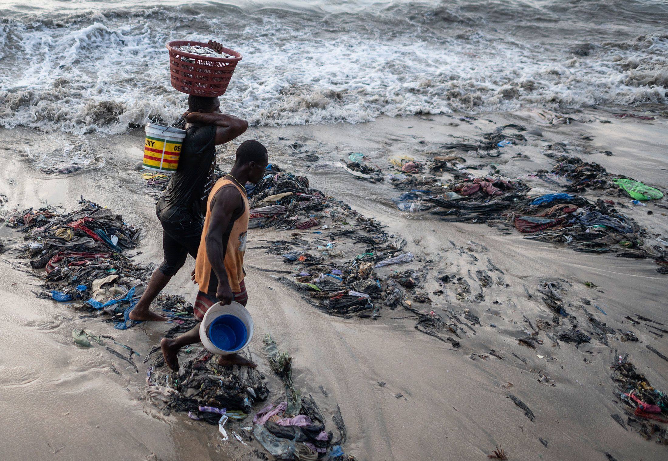 Fishermen walking across the refuse at Chorkor beach near Accra.