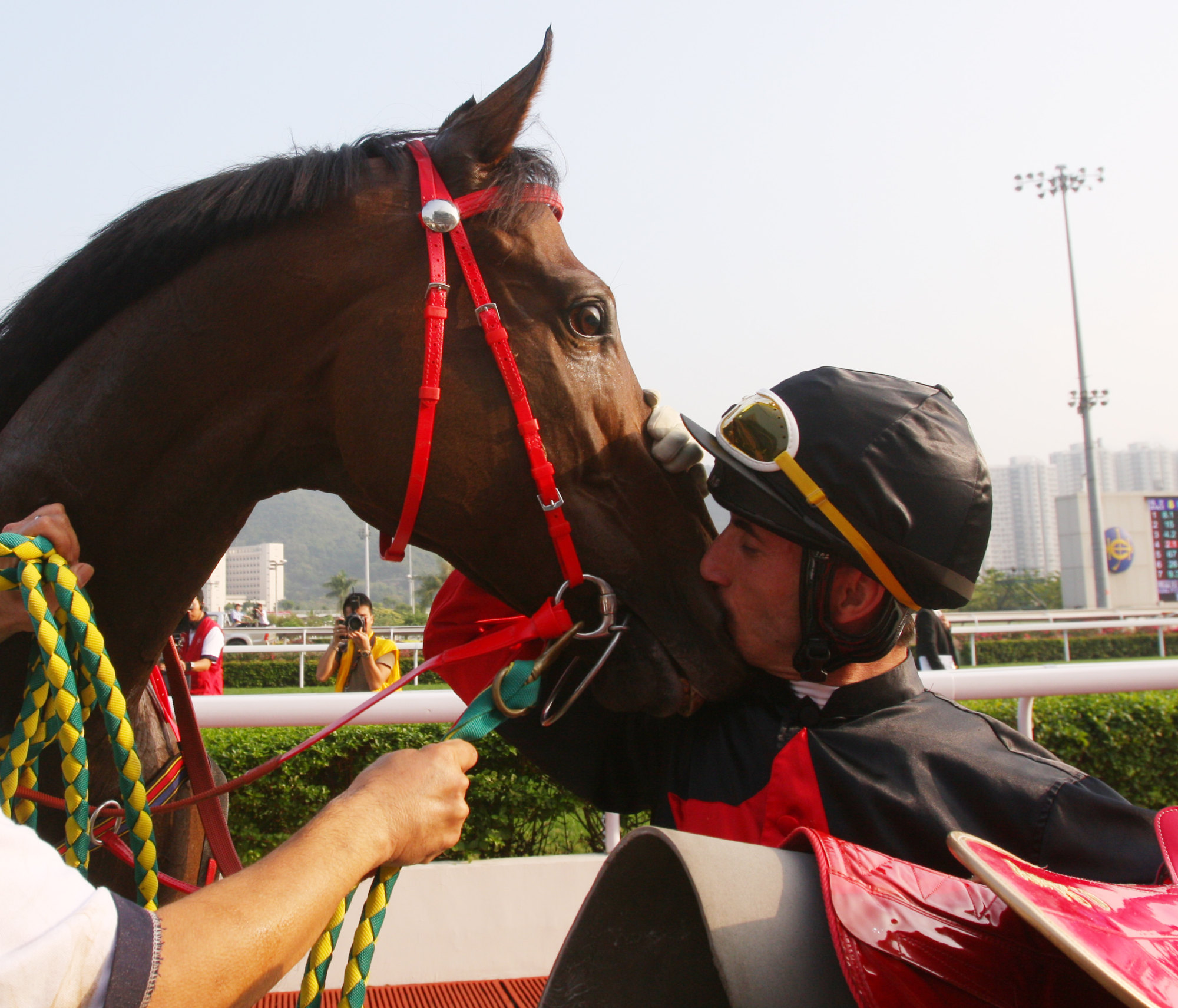 Olivier Doleuze gives Good Ba Ba a kiss after winning the Hong Kong Mile.
