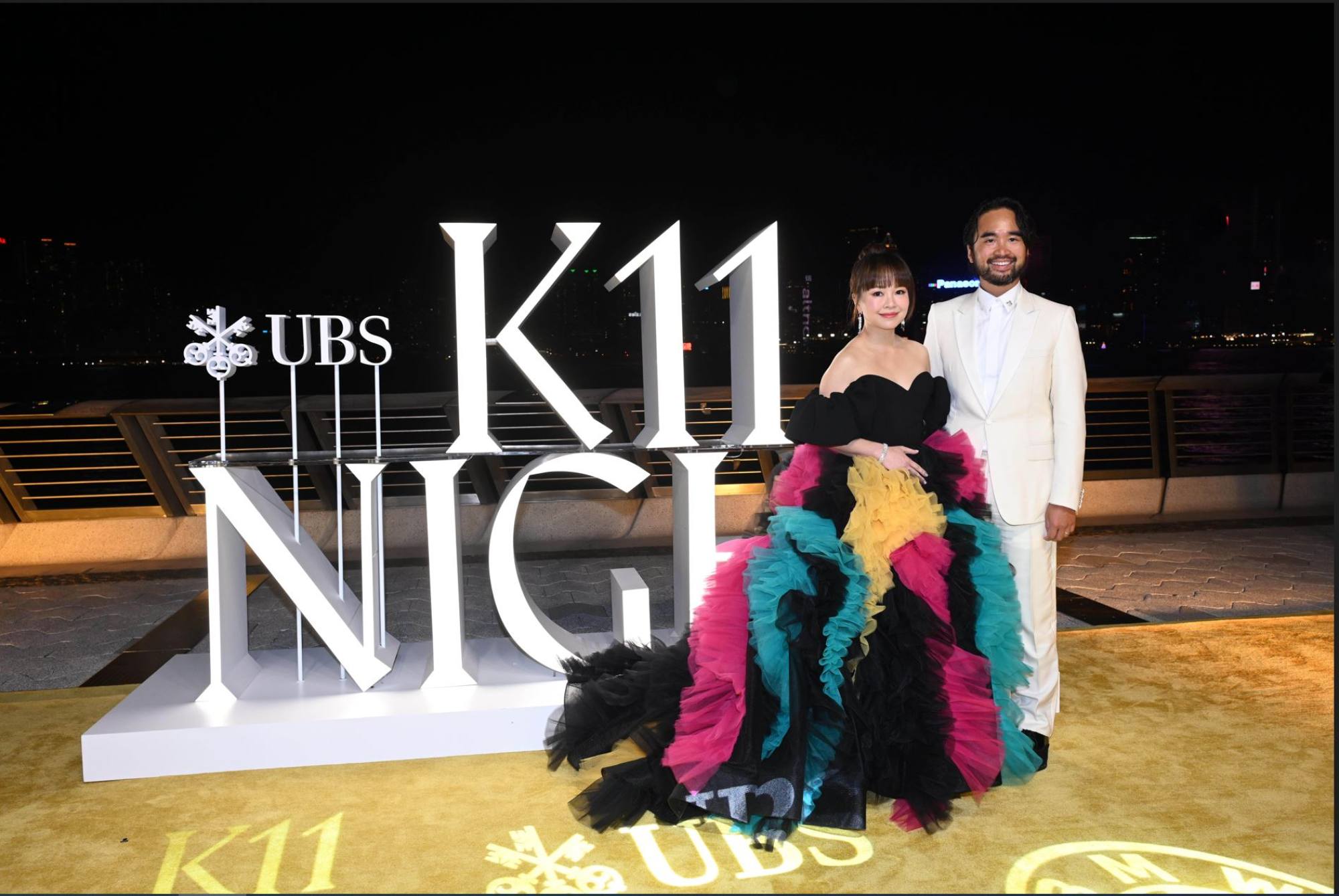 Adrian Cheng and Jennifer Yu Cheng (left) in Dior and Christian Siriano.