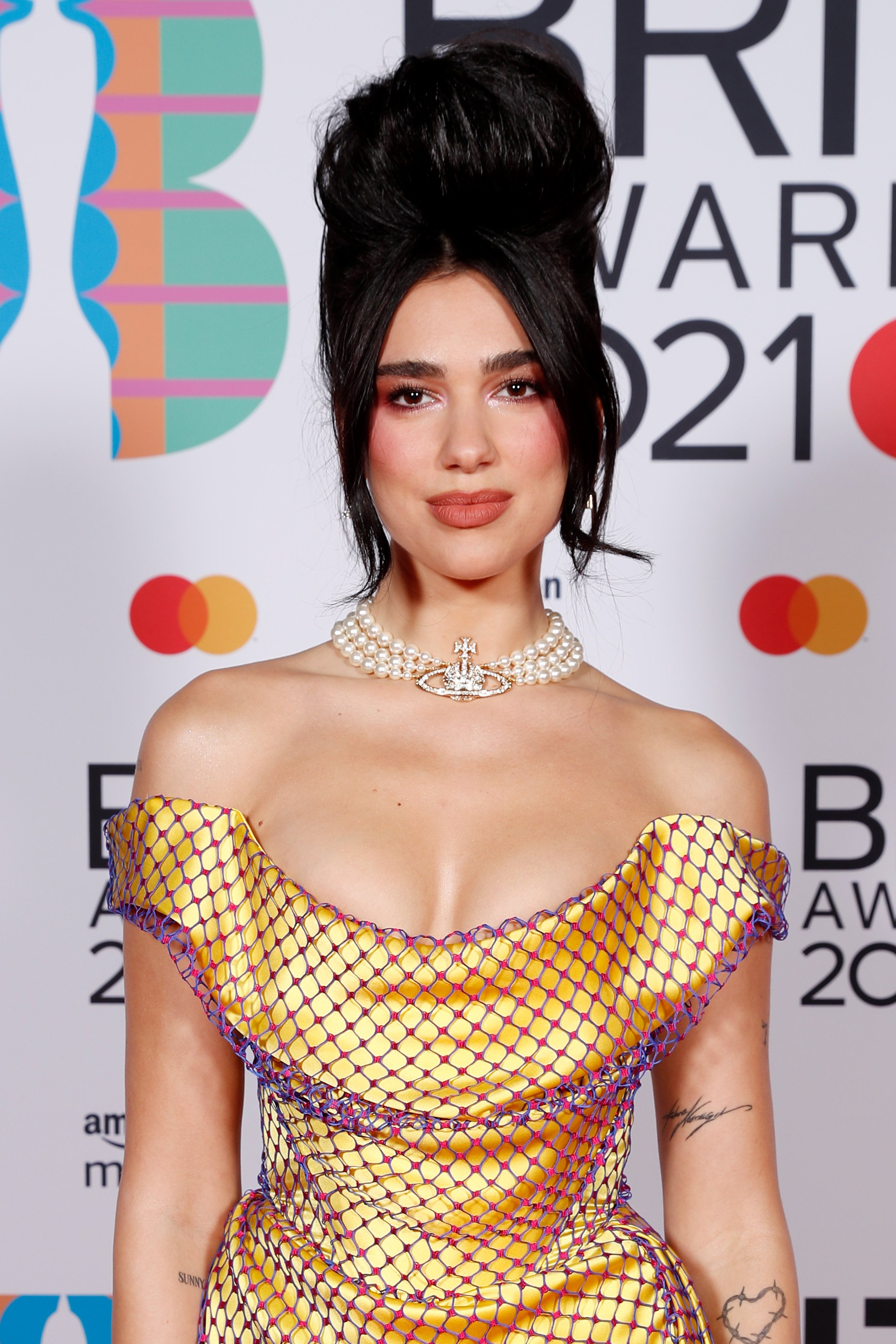 Dua Lipa wears a pearl necklace by Vivienne Westwood at the Brit Awards 2021 in London, England. Photo: JMEnternational for Brit Awards / Getty Images
