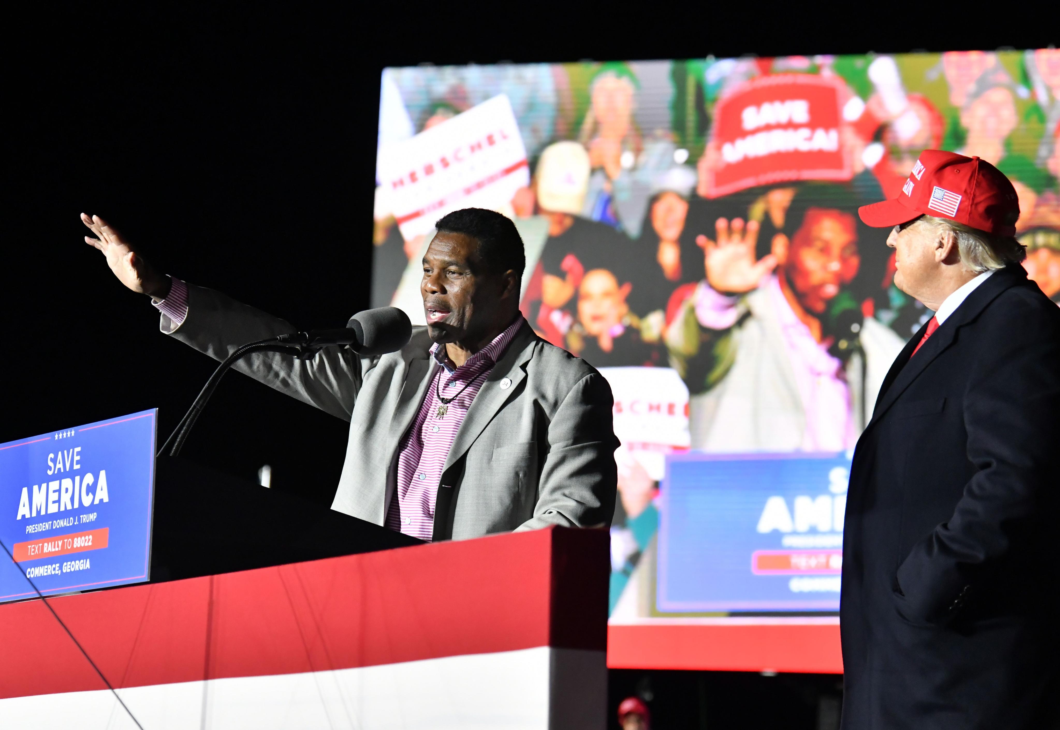 Herschel Walker speaks as former US president Donald Trump looks during a rally for Georgia Republican candidates at Banks County Dragway in Commerce, Georgia on March 26. Photo: TNS